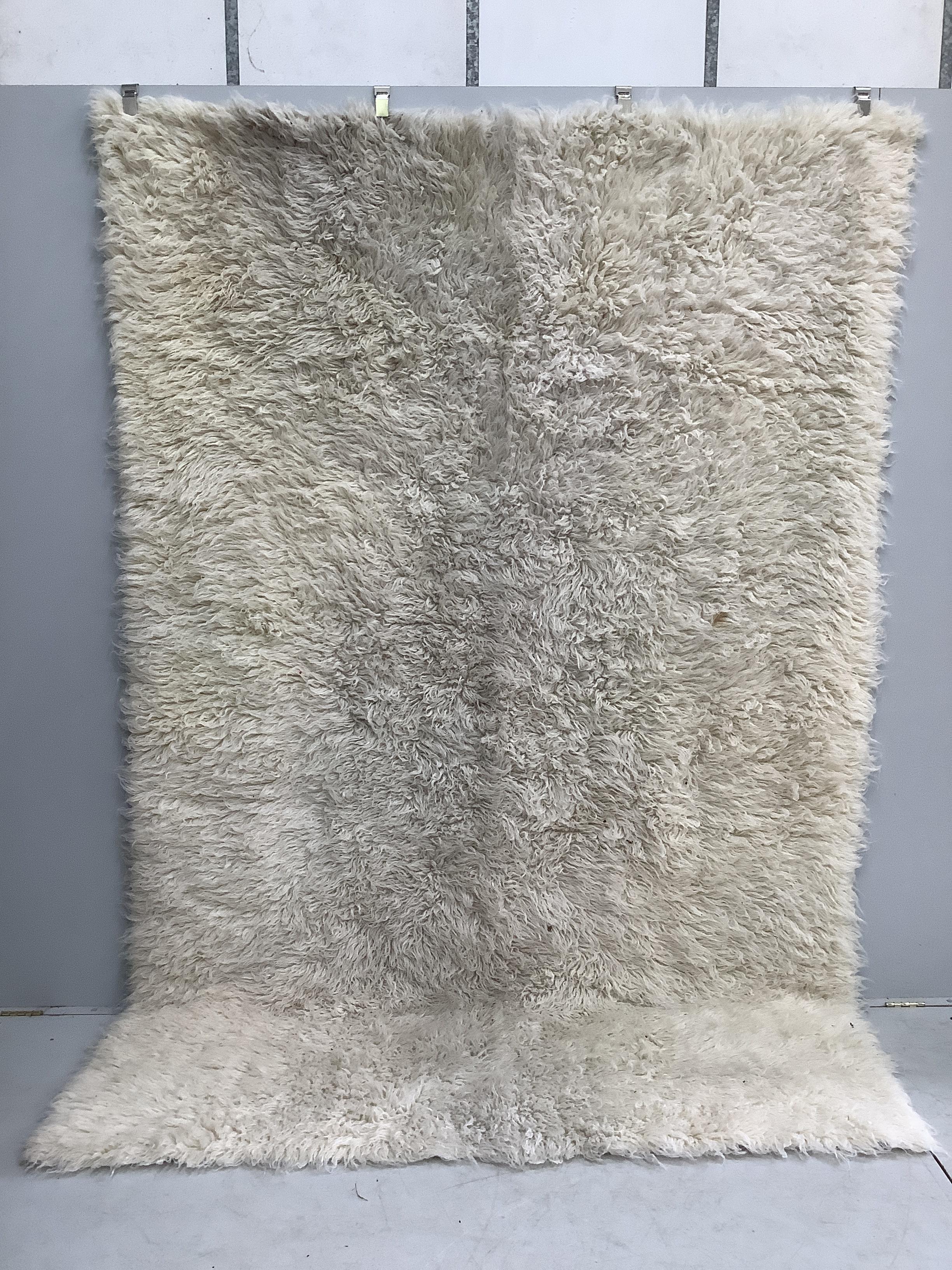 A faux sheepskin carpet, 290 x 200cm                                                                                                                                                                                        