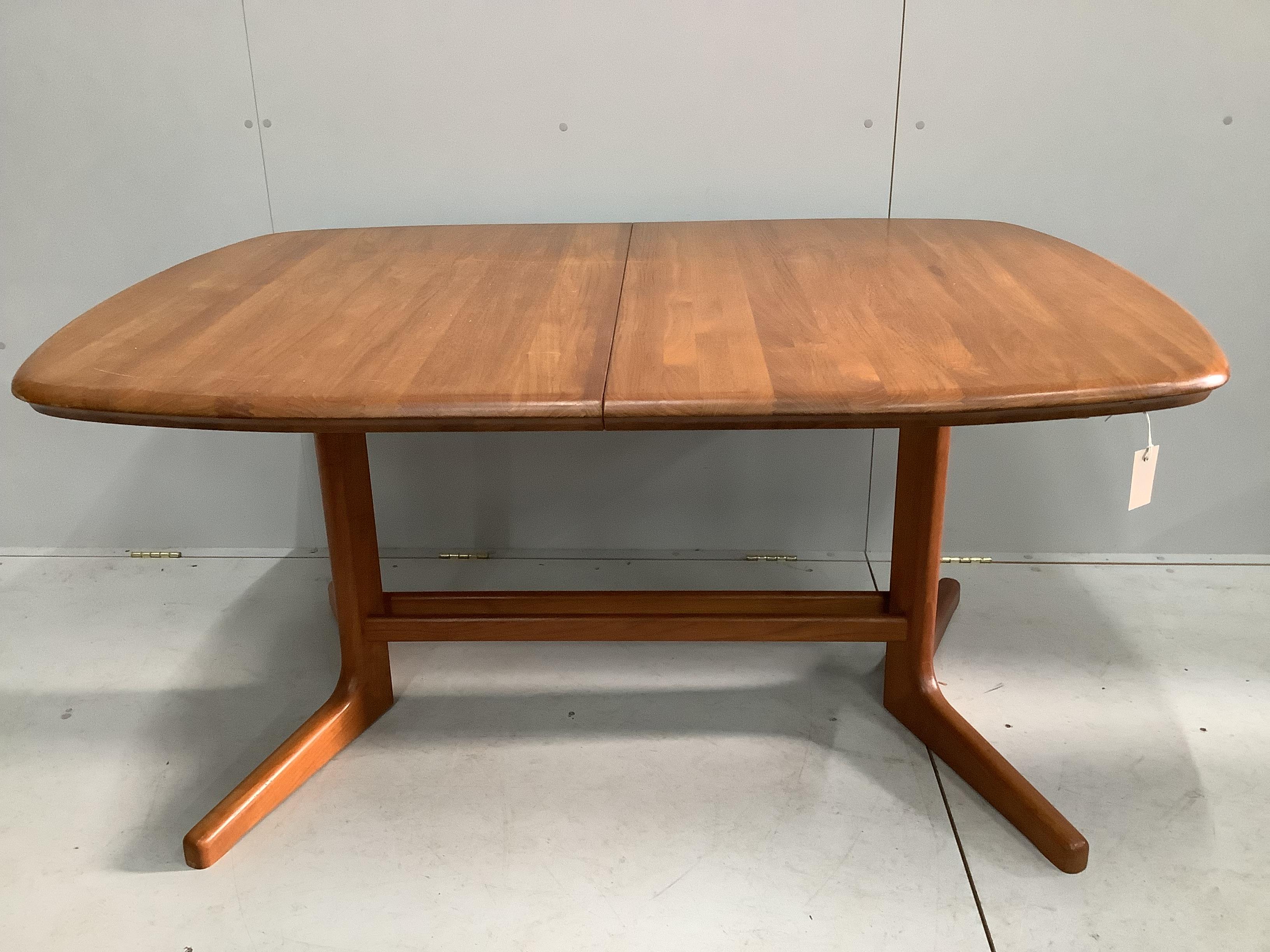 A mid century teak extending dining table, length 150cm, width 106cm, height 74cm and six chairs, two with arms                                                                                                             