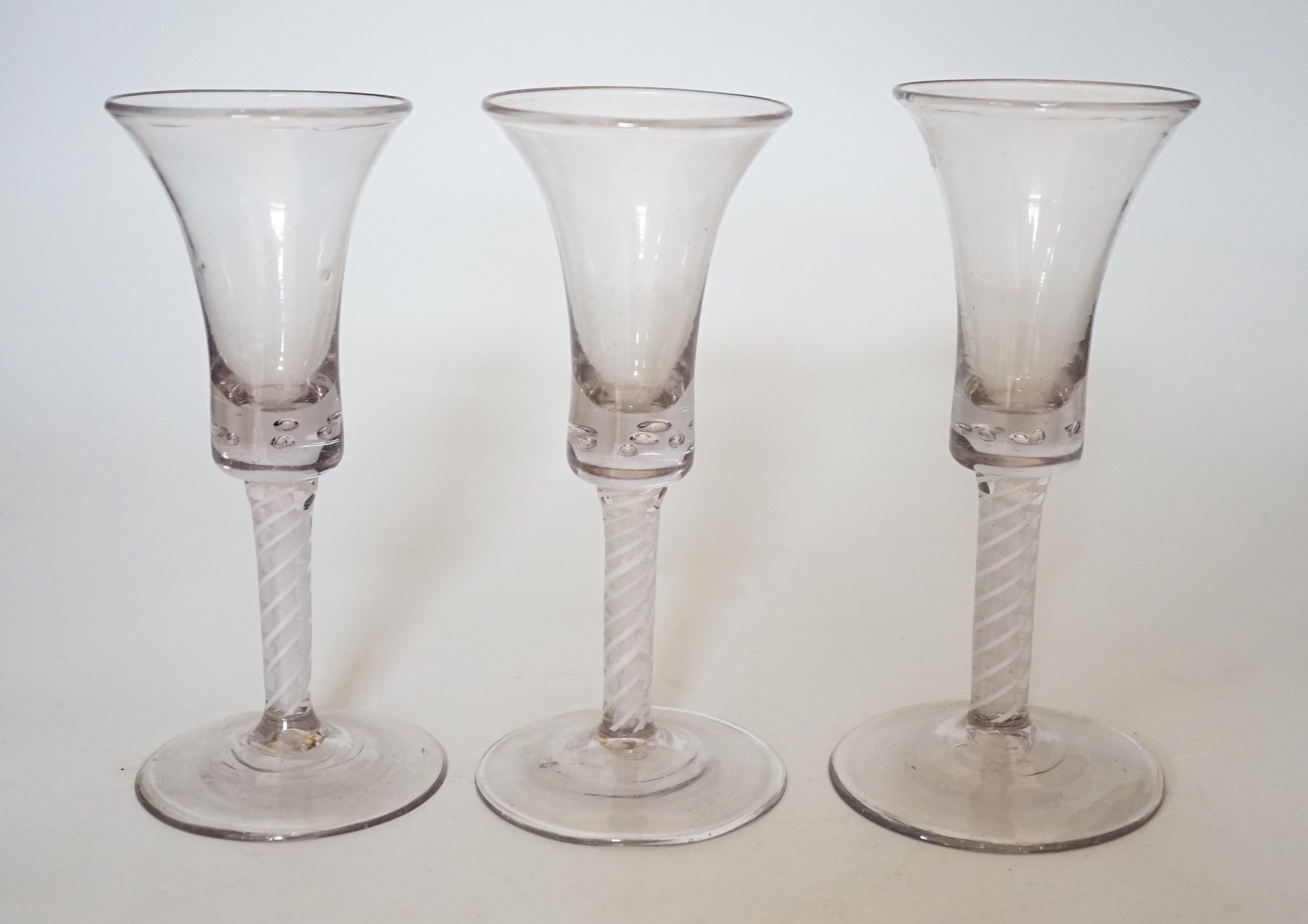 A trio of George III style cotton twist stemmed glasses, 17.5cms high                                                                                                                                                       