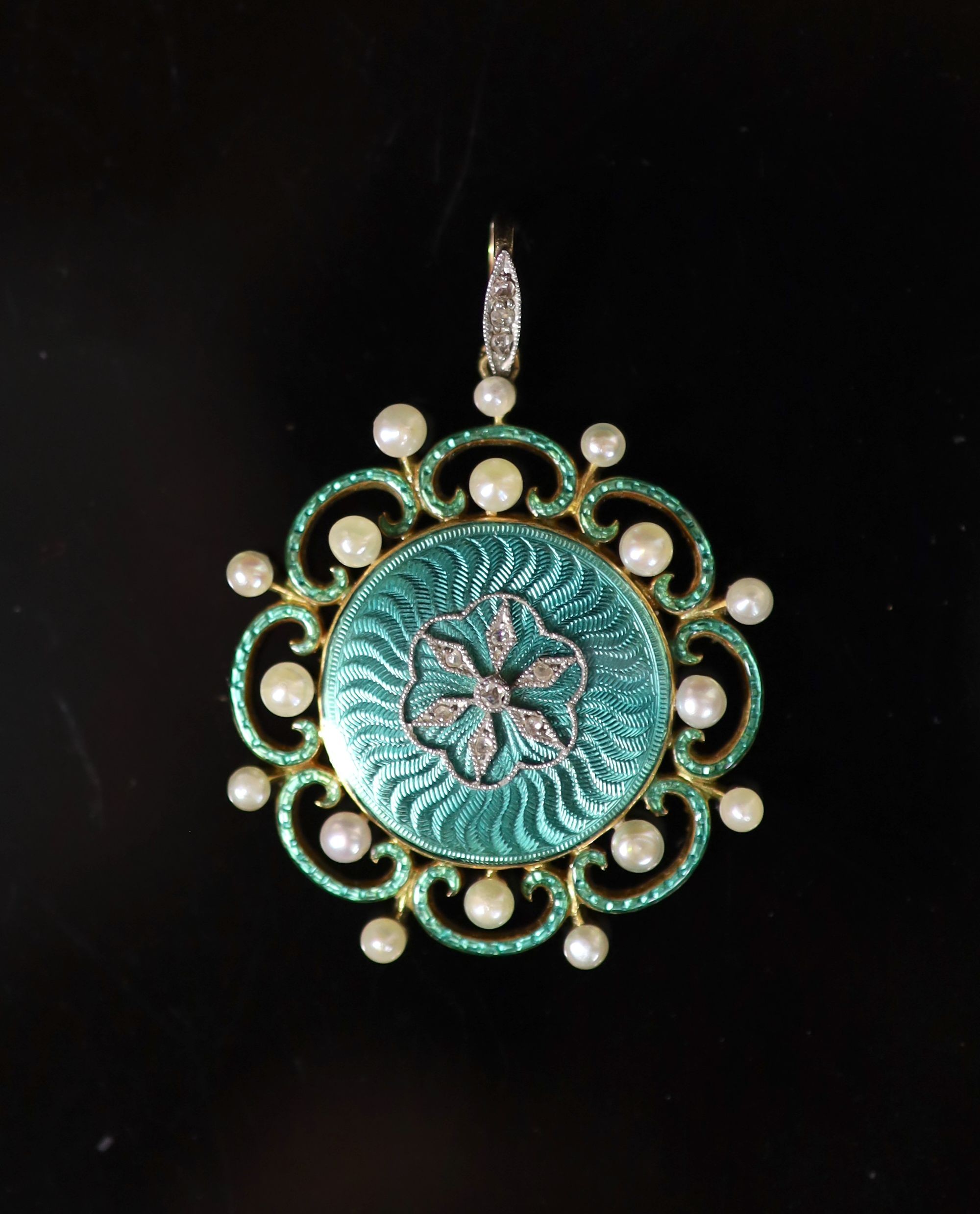 A Belle Epoque gold, green enamel, seed pearl and rose cut diamond set circular pendant                                                                                                                                     