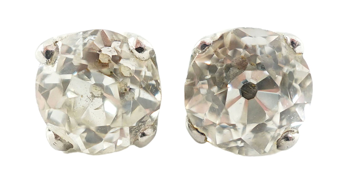 A pair of white gold? and solitaire diamond set ear studs                                                                                                                                                                   