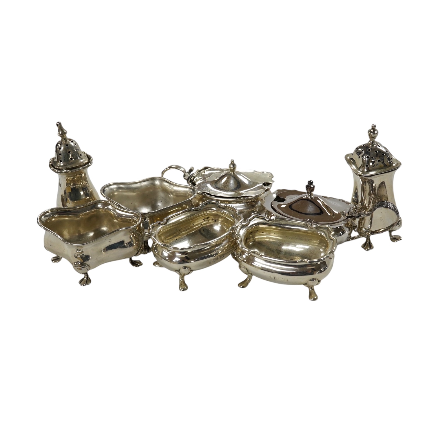 Eight assorted silver cruets including salts and mustard pots, various dates and makers, Condition - poor to fair                                                                                                           