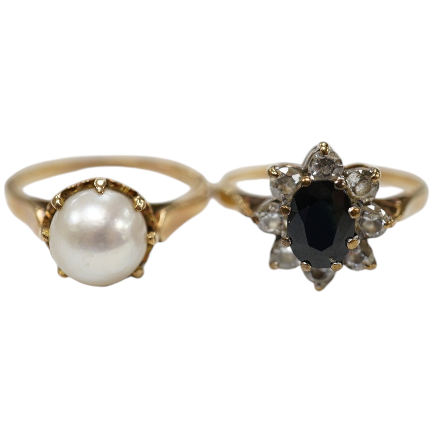 A 9ct gold, sapphire and simulated diamond cluster set ring, size M and a 9ct gold and cultured pearl set ring, gross weight 5 grams. Condition - fair                                                                      