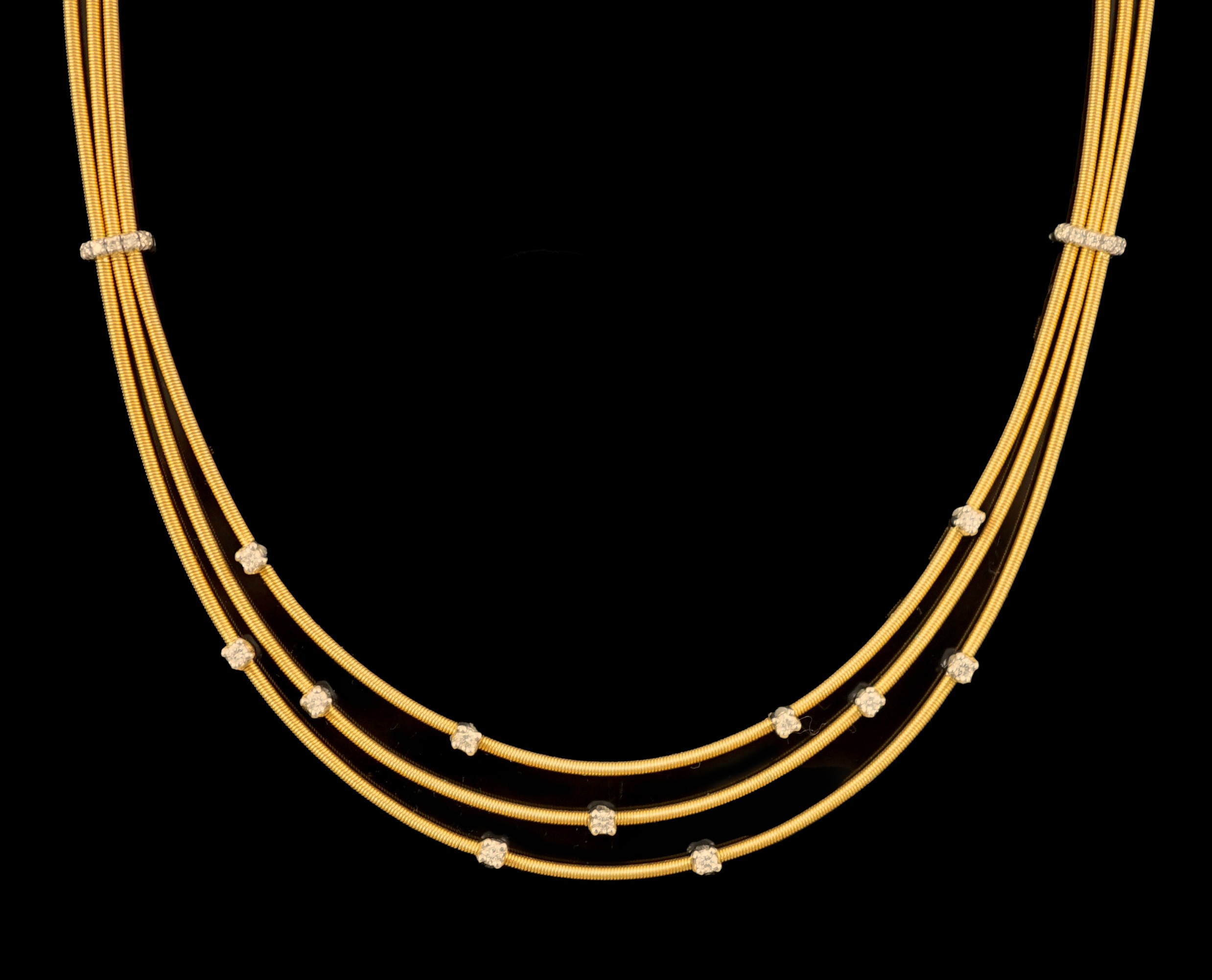 A modern Italian Marco Bicego 18ct gold and eleven stone diamond chip set triple strand necklace                                                                                                                            
