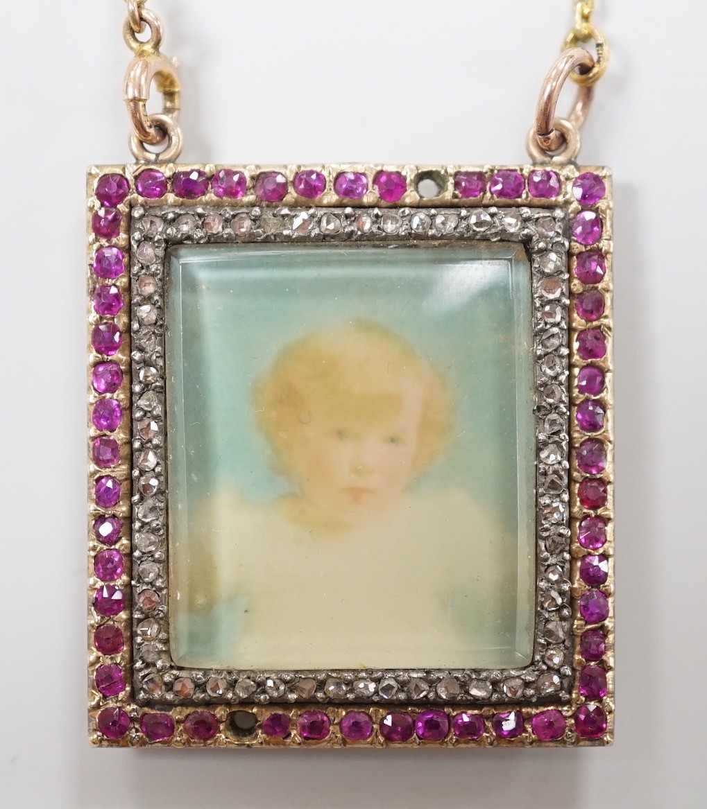 An early 20th century yellow metal, ruby and diamond mounted portrait pendant, 34mm (two rubies missing), on a 9ct chain                                                                                                    