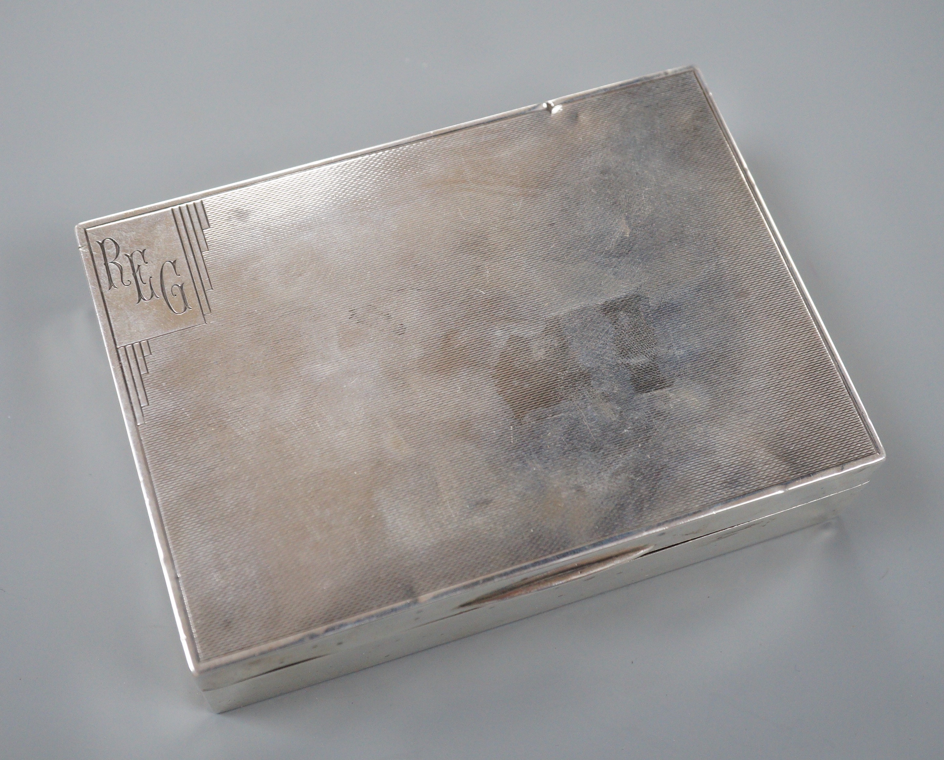 A George V engine turned silver rectangular cigarette box, Mappin & Webb, London, 1933, 12.8cm.                                                                                                                             