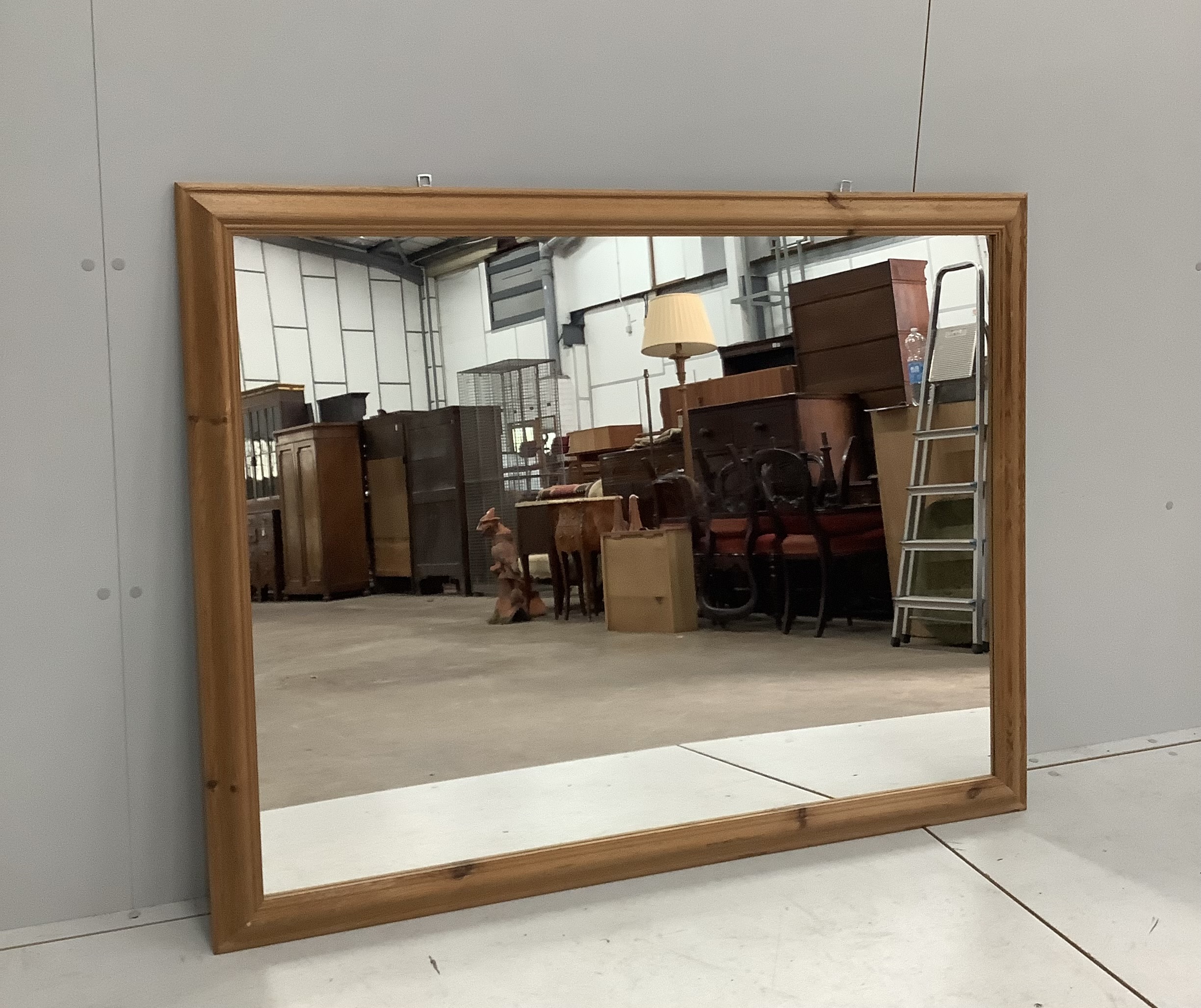 A rectangular pine framed wall mirror, width 132cm, height 102cm                                                                                                                                                            
