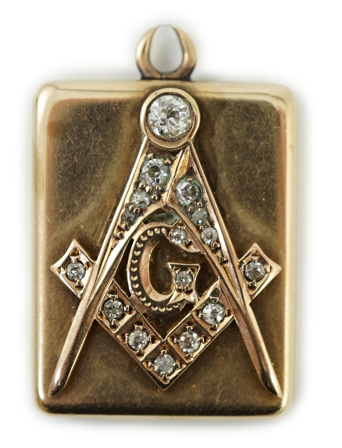 An Edwardian yellow metal and diamond cluster set masonic locket pendant, with engraved inscription verso 'Presented to Henry Drucker by Wm. McKinley', overall 33mm, gross weight 12.3 grams.                              