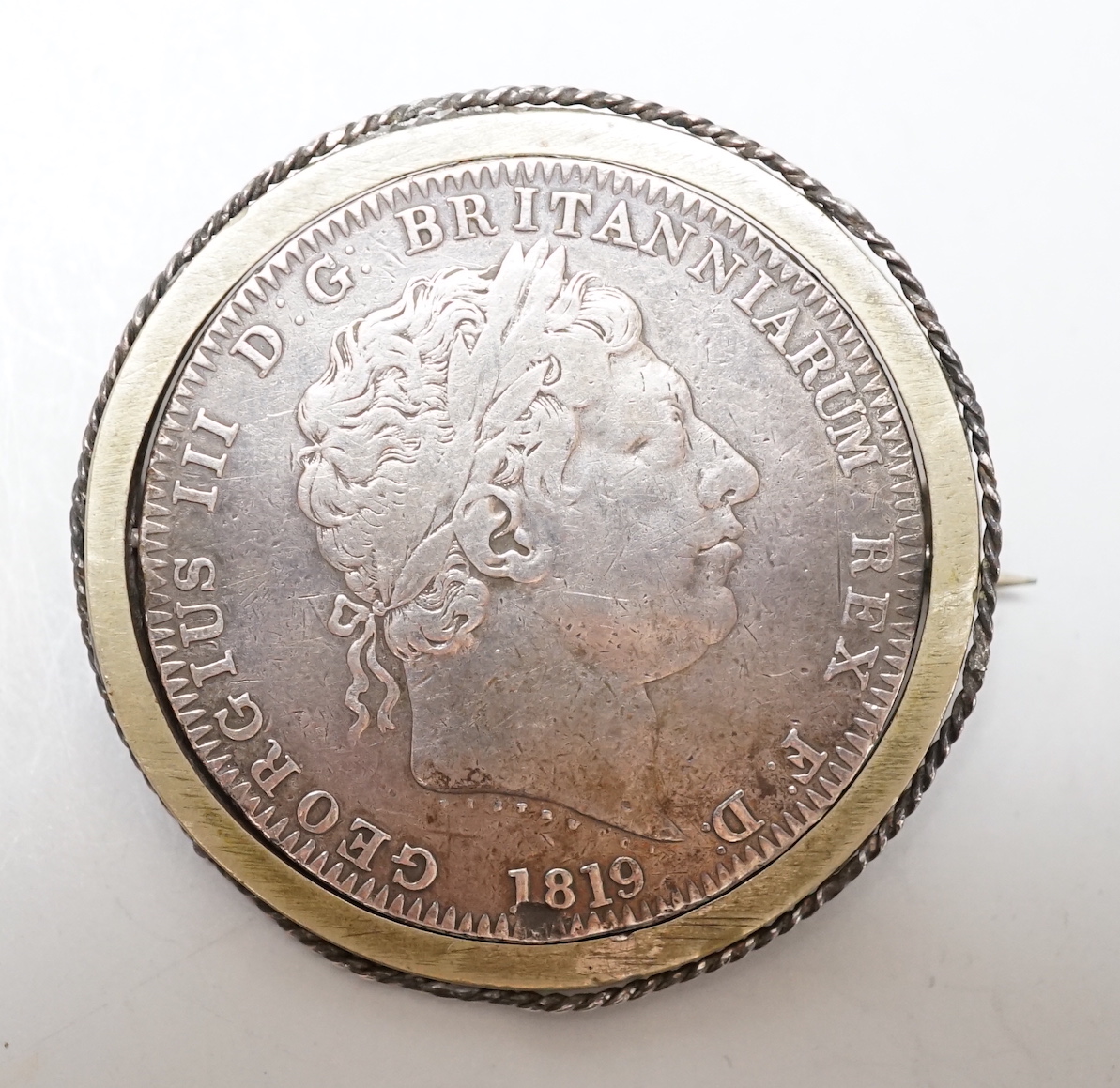 An 1819 crown mounted as a swivel brooch                                                                                                                                                                                    