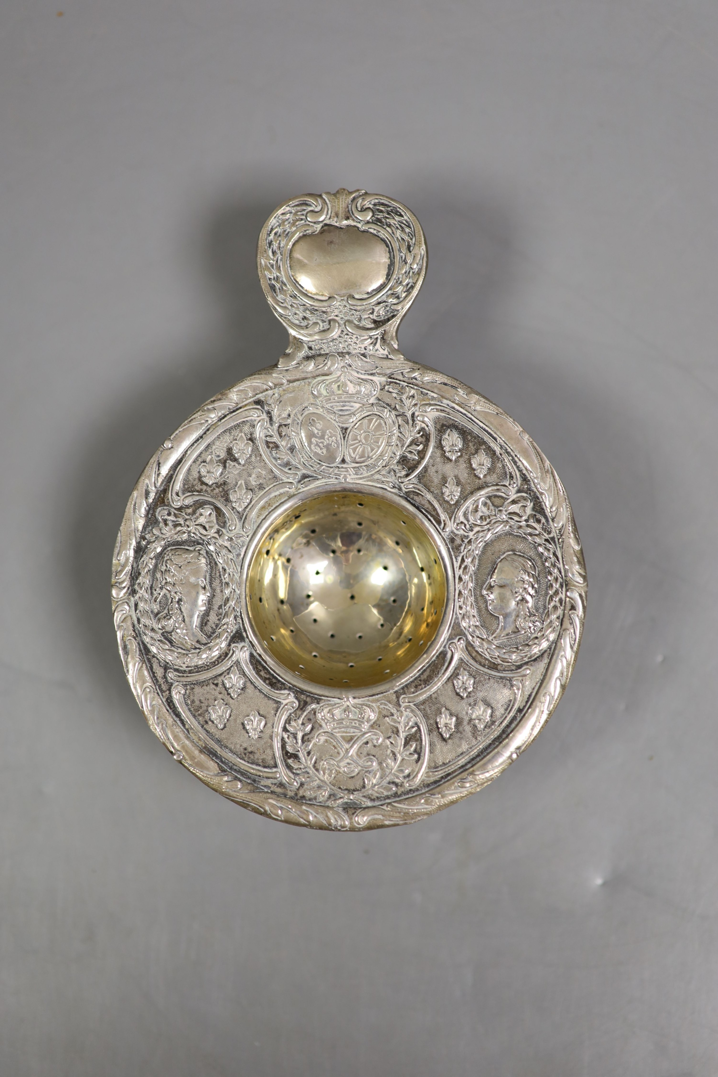 A 19th century continental white metal strainer, 13.6cm and the top section of a George III wine funnel, London, 1797, diameter 87mm, gross 121 grams.                                                                      