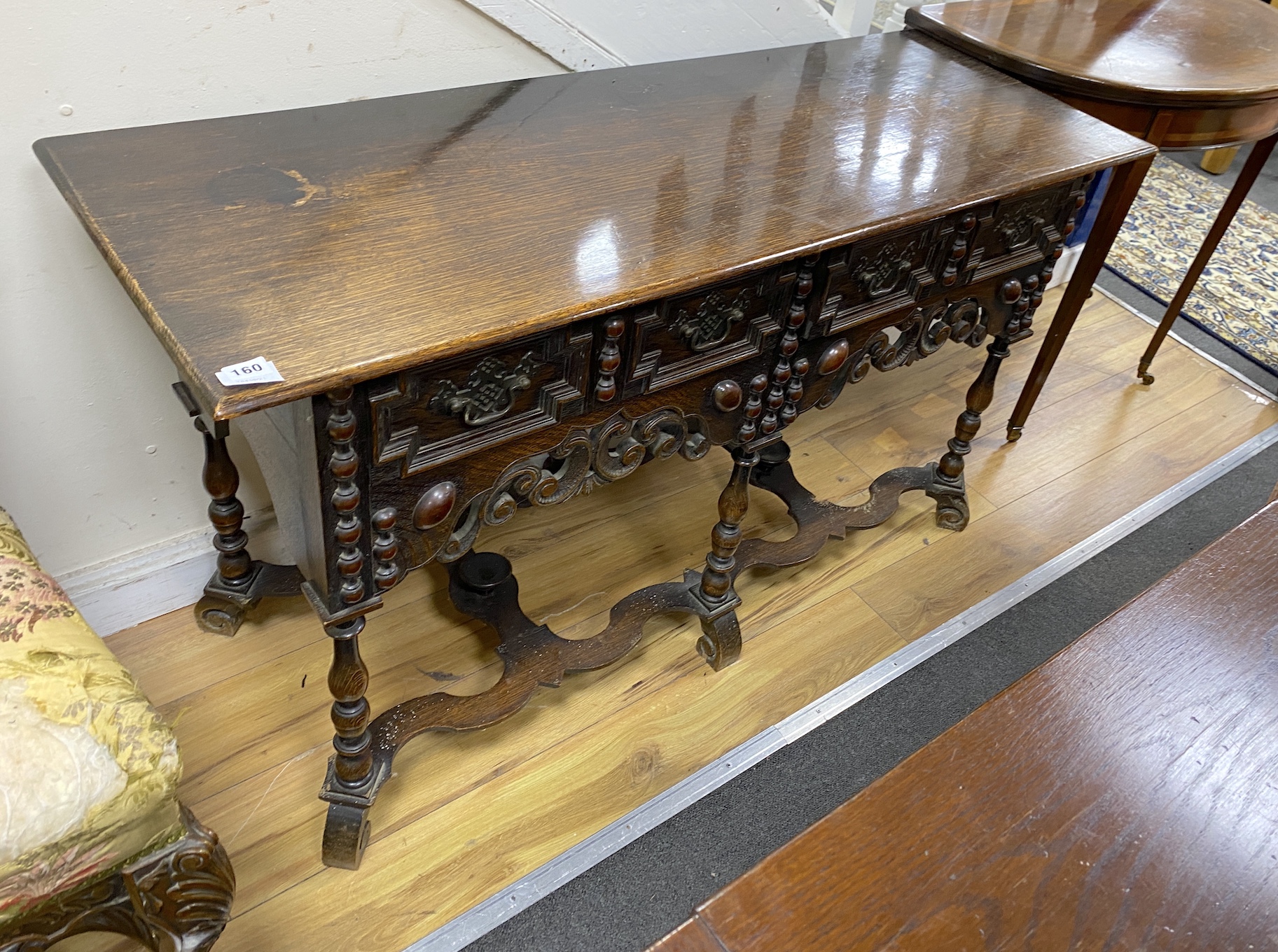 A small Jacobean revival oak two drawer serving table, width 128cm, depth 46cm, height 72cm                                                                                                                                 