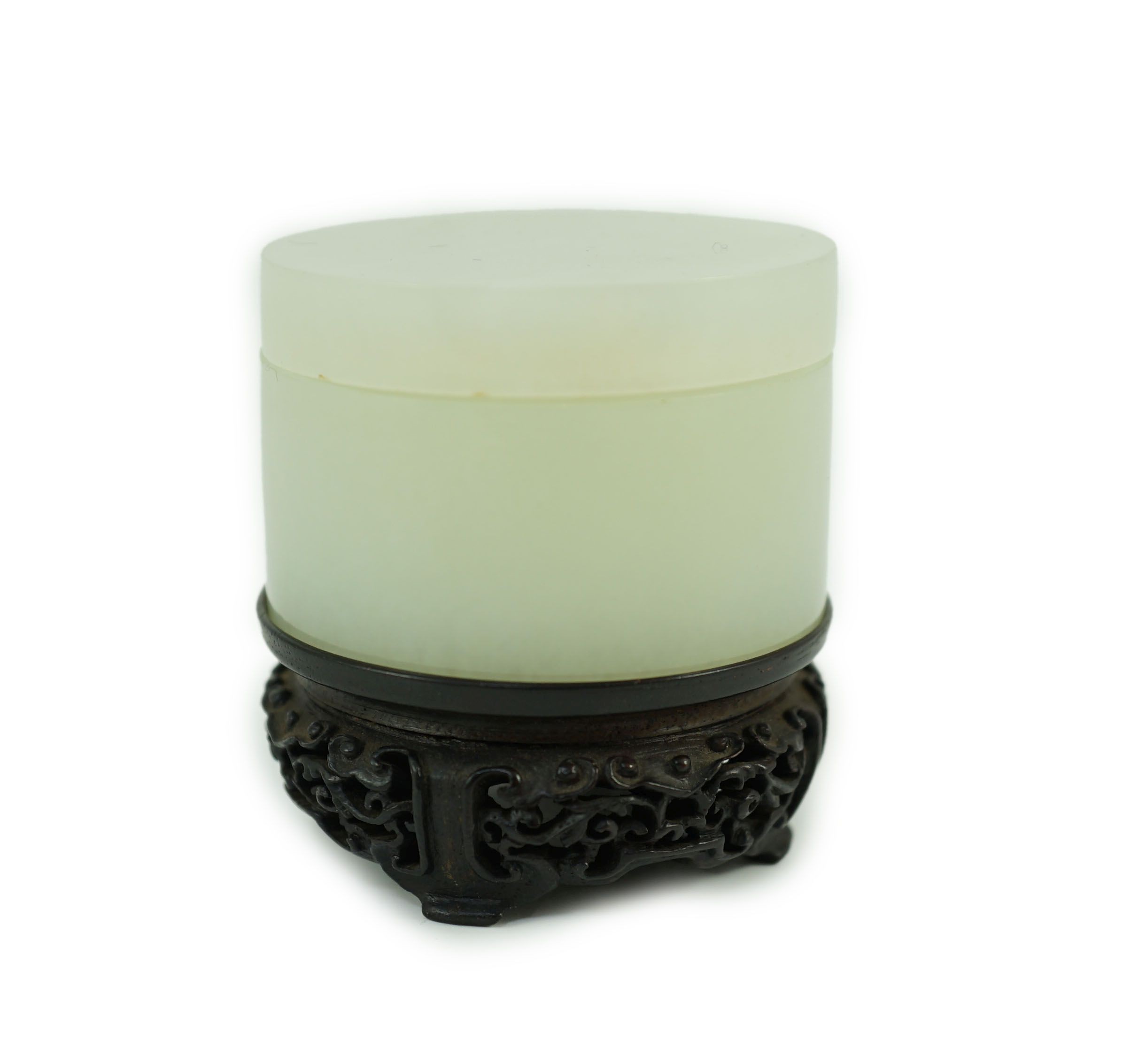 A Chinese pale celadon jade cylindrical box and cover, 18th/19th century, 5.3 cm diameter, zitan wood stand                                                                                                                 