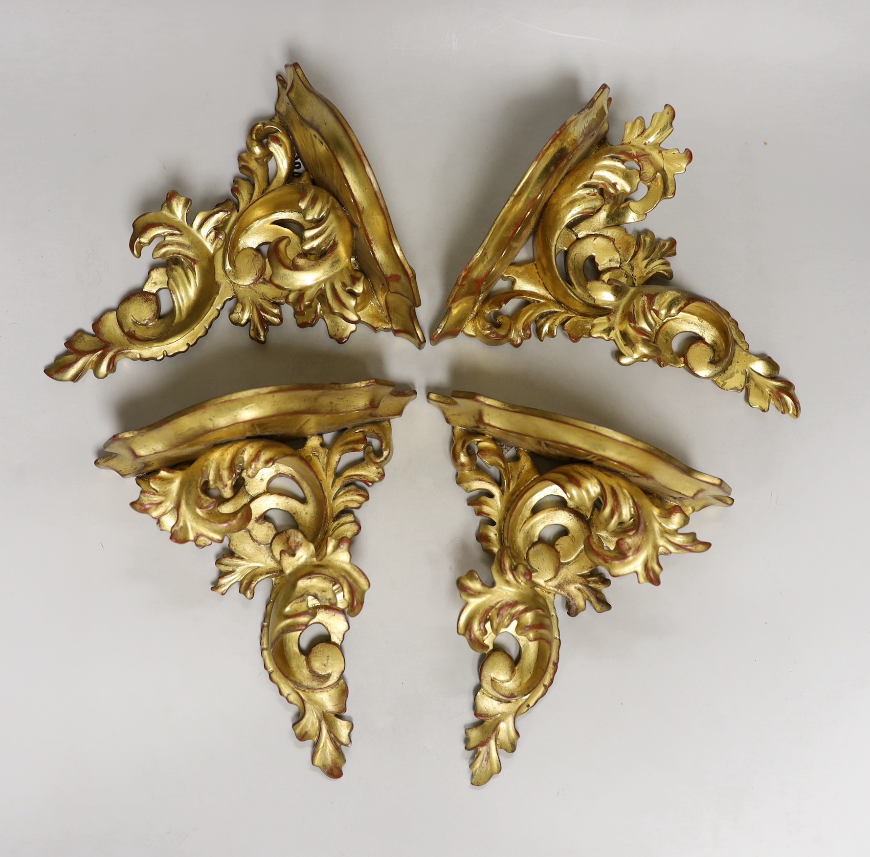 A set of four gilt wood wall brackets 22.5cm tall x 20.5cm wide                                                                                                                                                             