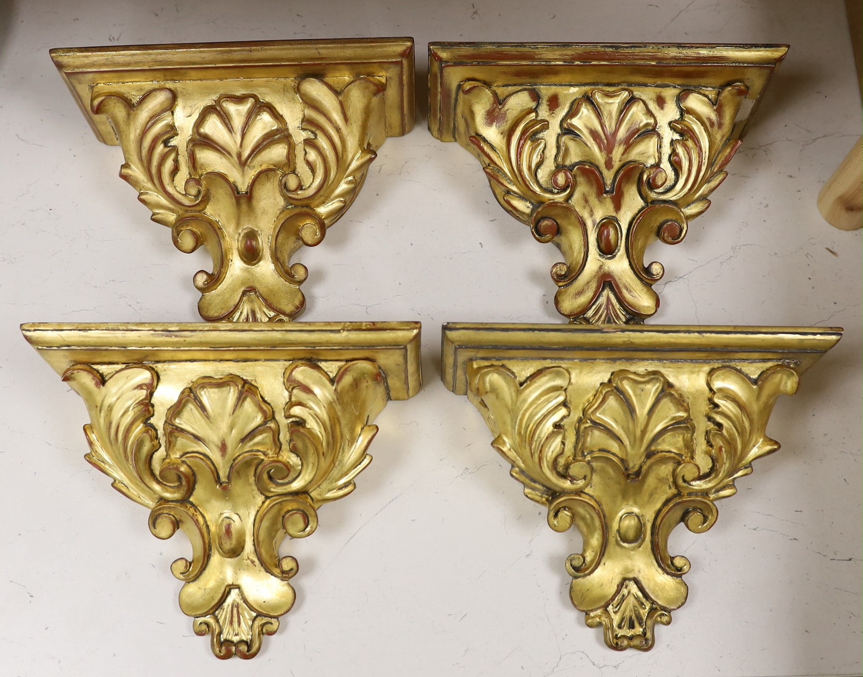 A set of four gilt wood wall brackets, 18.5cm tall x 24cm wide                                                                                                                                                              