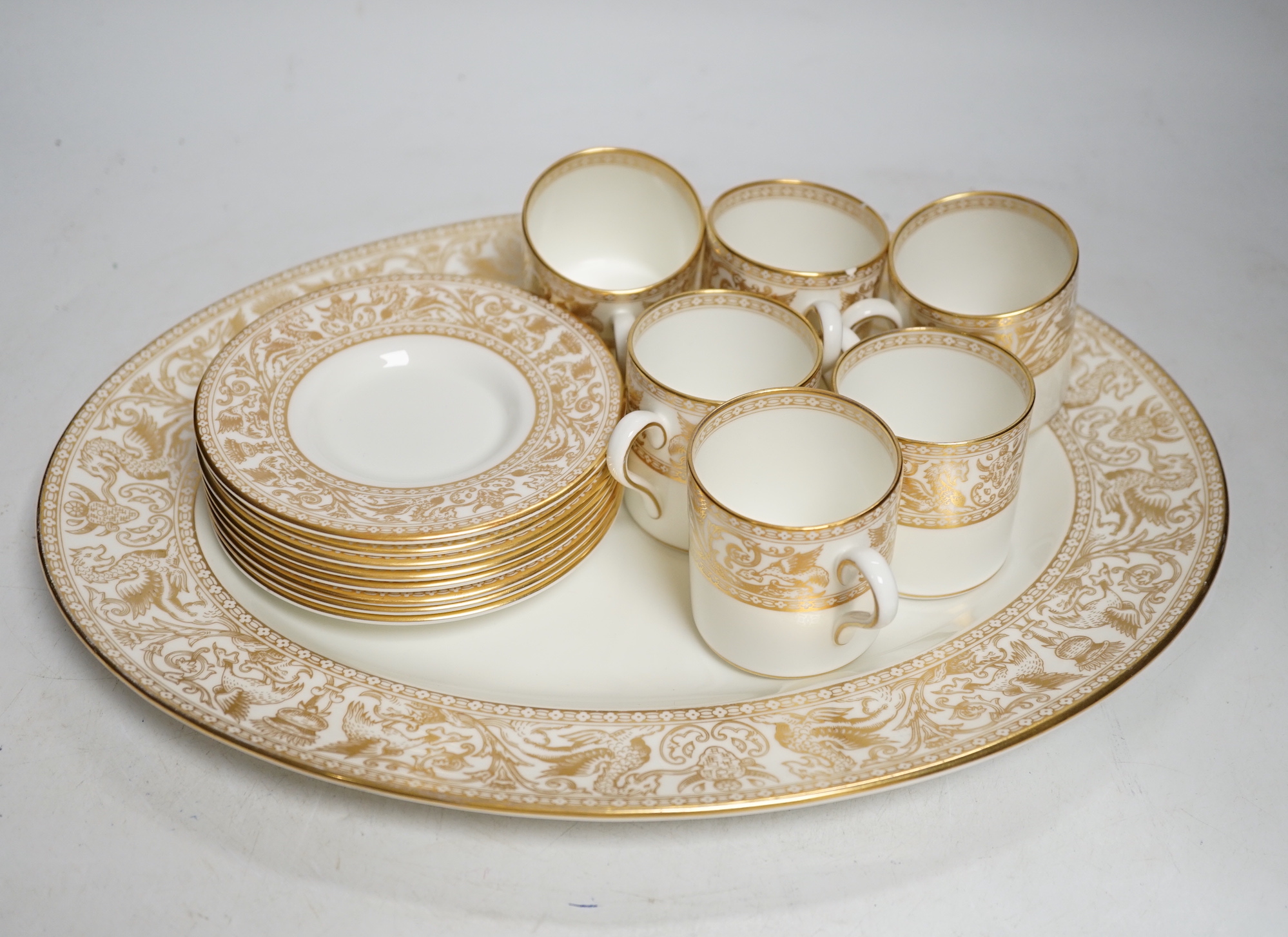 A Wedgwood Gold Florentine dinner and coffee service, mostly 8-12 settings, largest 39cm wide                                                                                                                               