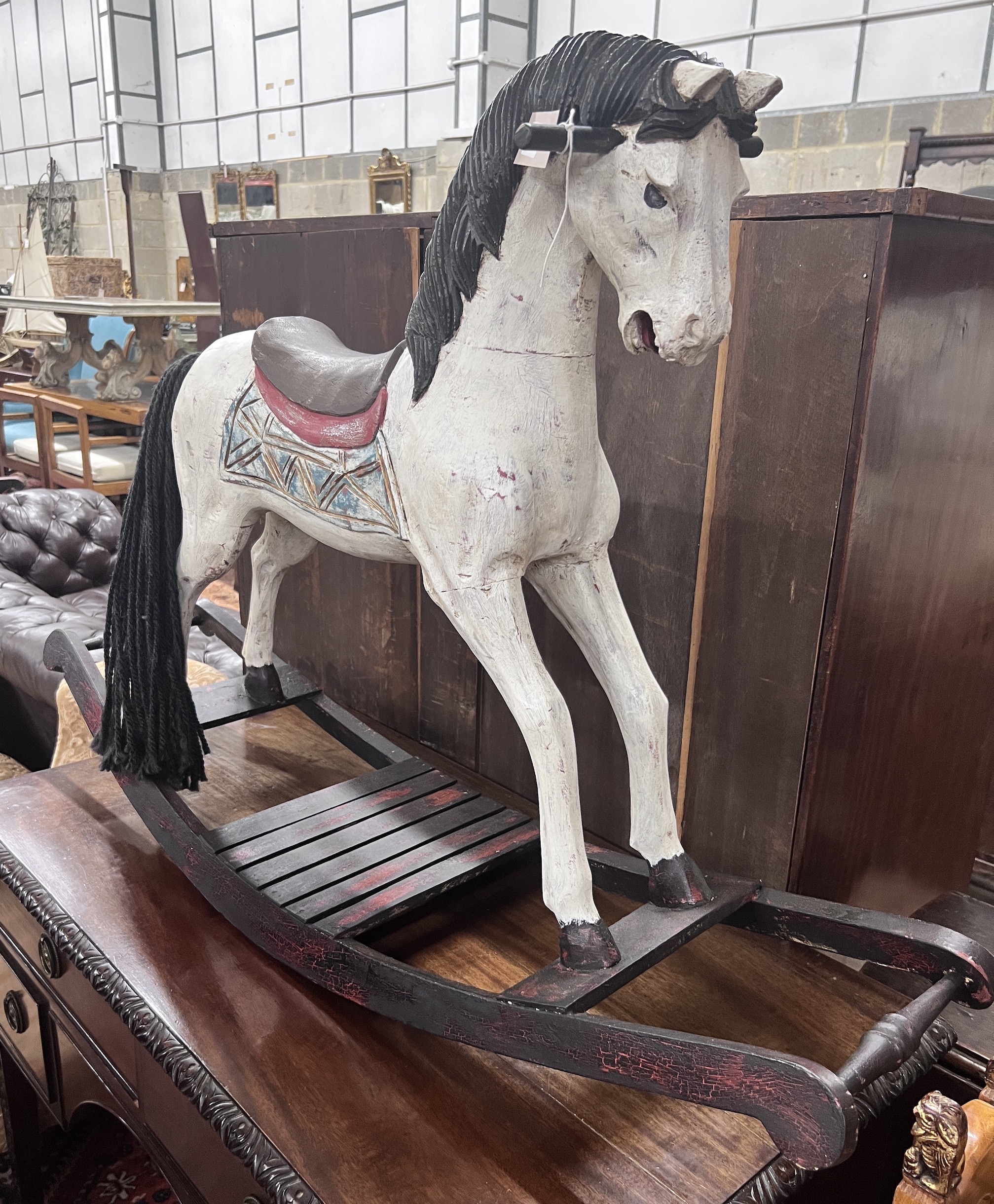 A Victorian style painted hardwood rocking horse, height 80cm                                                                                                                                                               