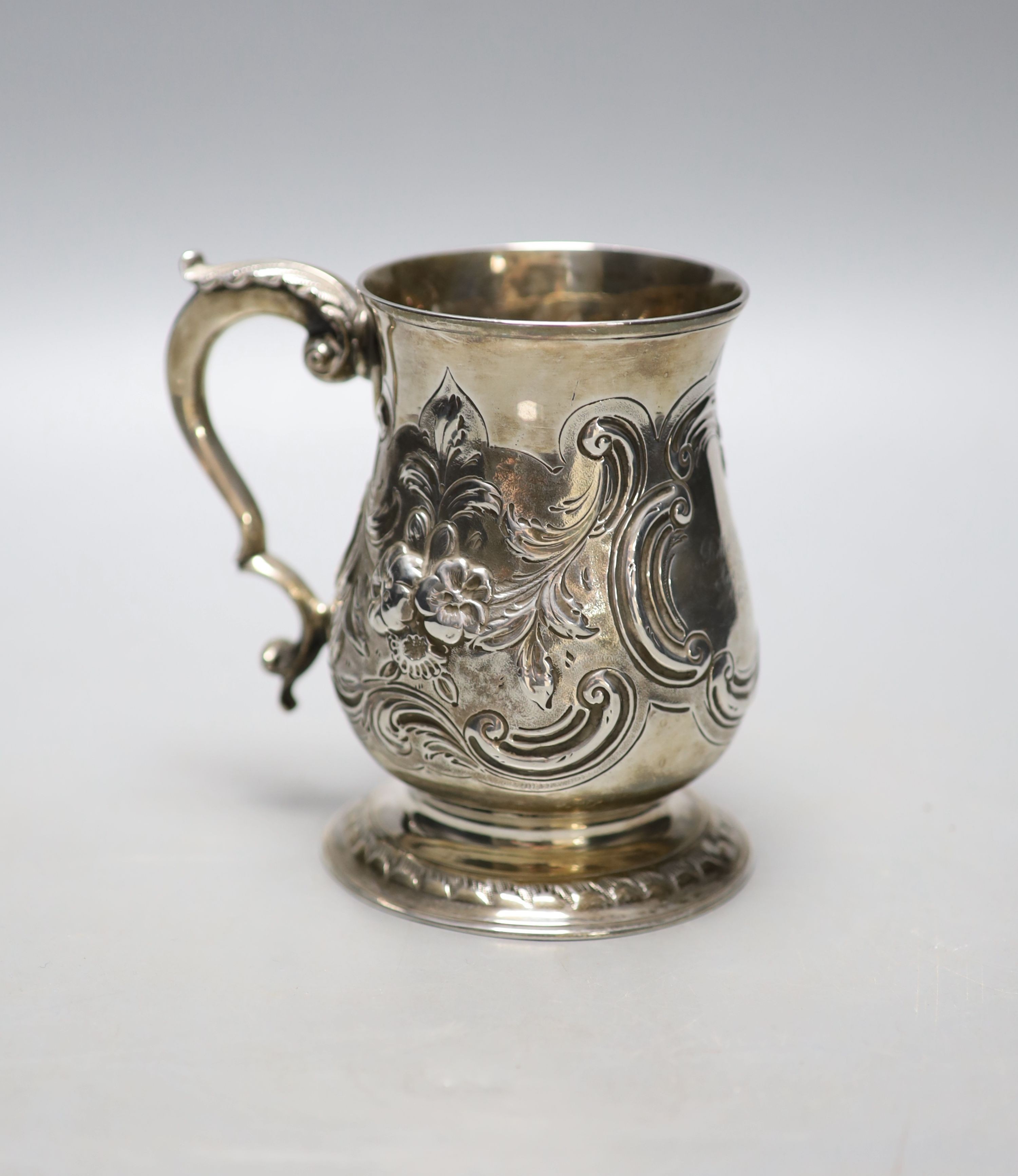 A George III silver baluster mug, with later embossed decoration and later engraved inscription, Langlands & Robertson, Newcastle, 1788, height 12.8cm, 11oz.                                                               