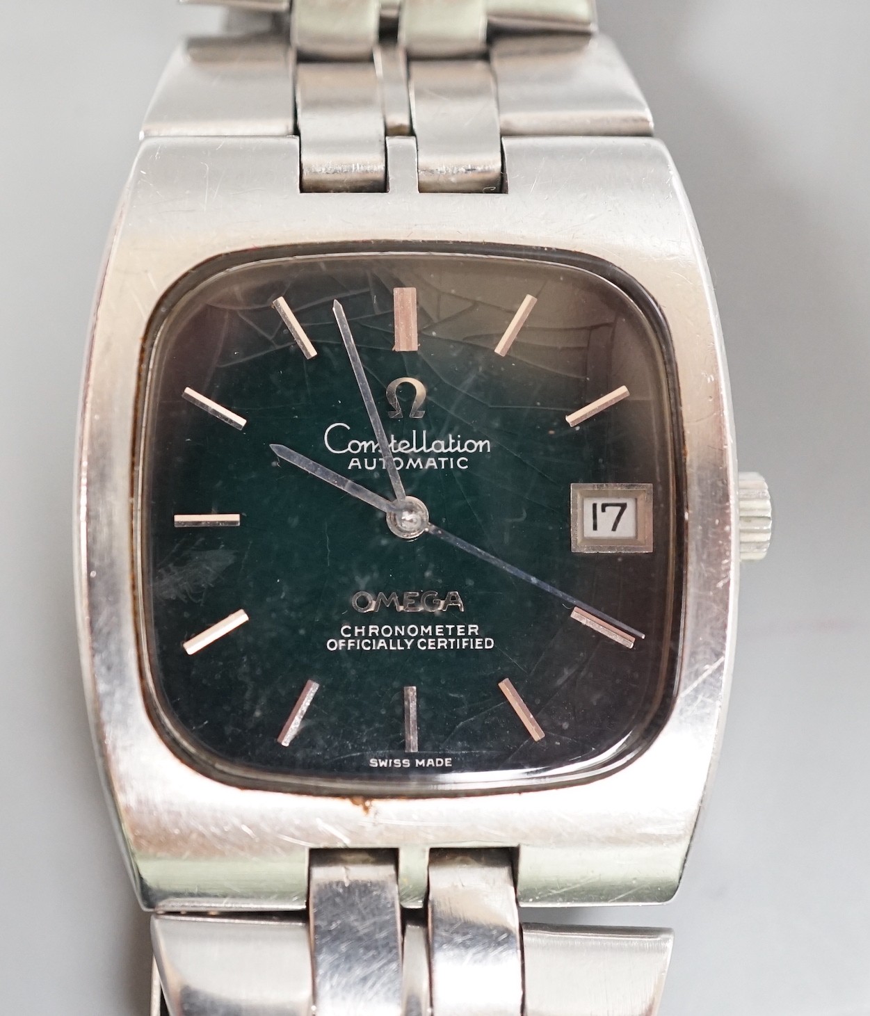 A gentleman's early 1970's stainless steel Omega Constellation chronometer black dial wrist watch, with bate numerals and date aperture, on stainless steel Omega bracelet, case diameter 33mm, with Omega box.             
