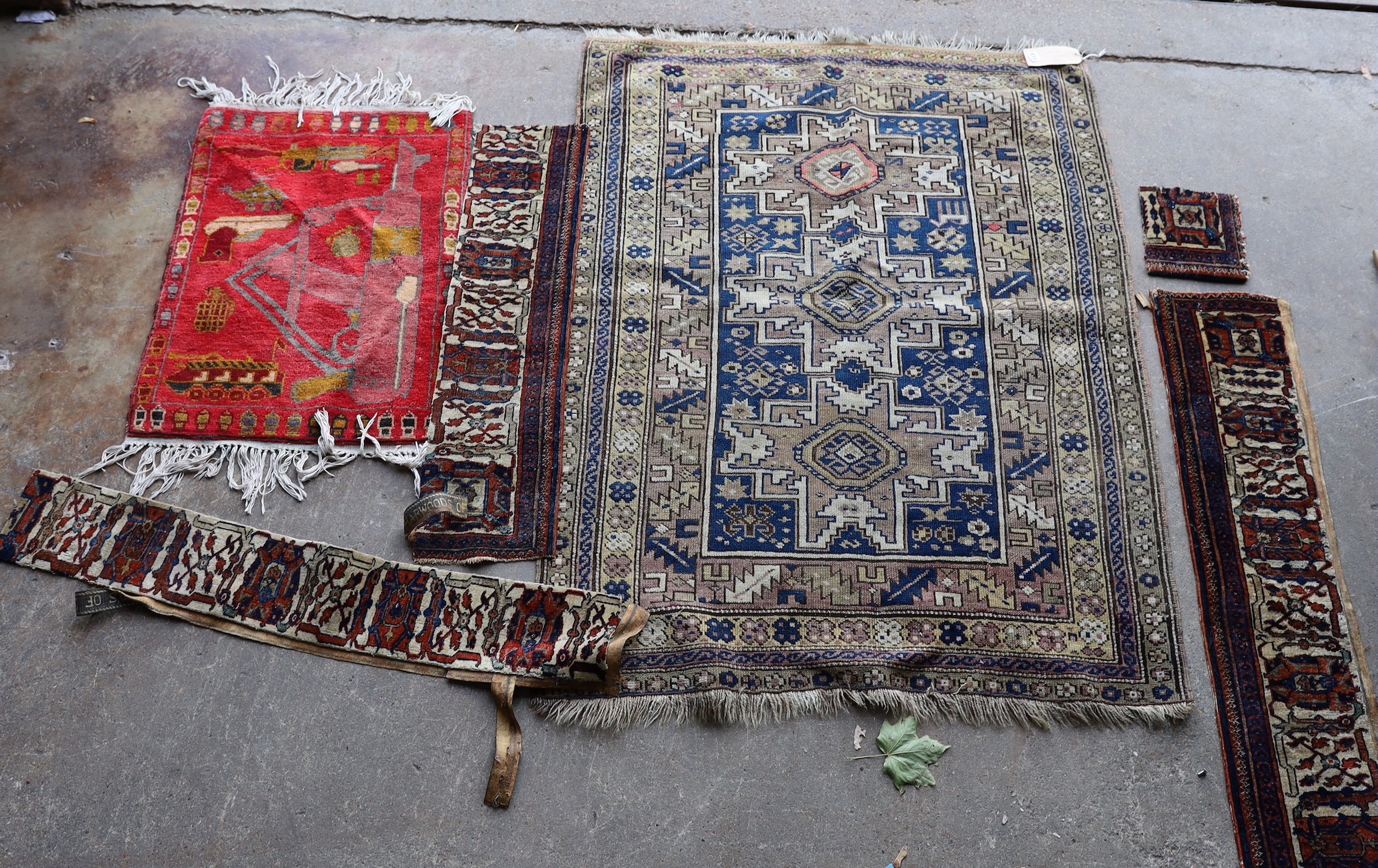 An antique Caucasian Derbend rug, 160 x 108cm, a smaller red ground rug and rug fragments                                                                                                                                   