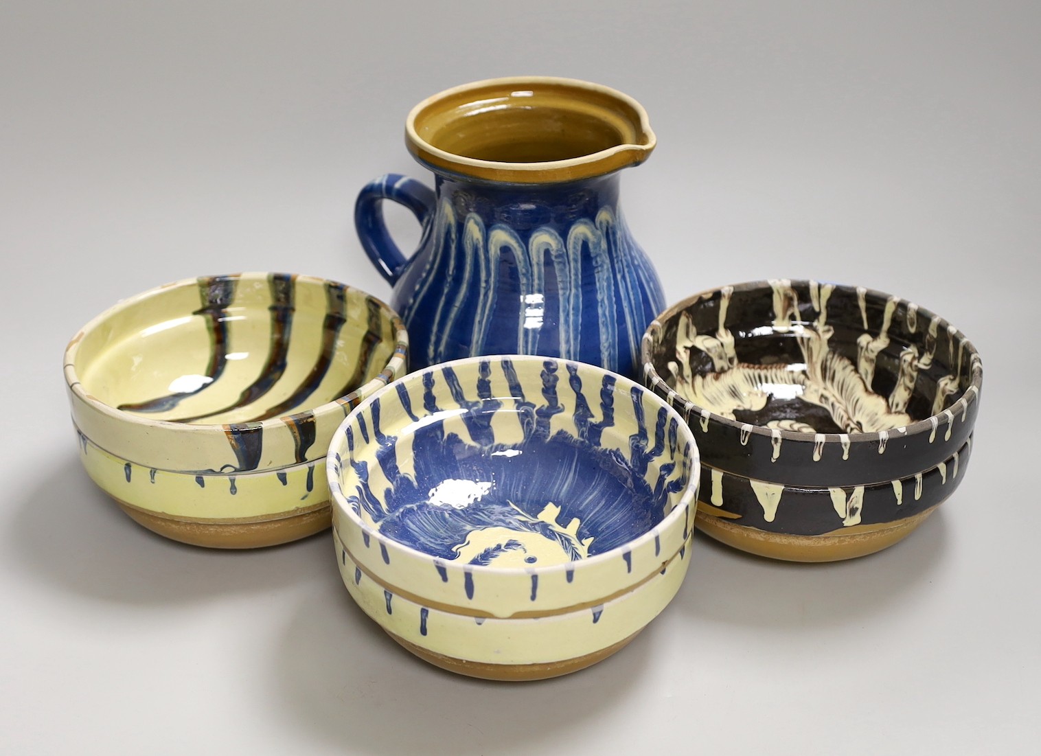 A group of six polychrome slipware bowls and a jug- 18cms high                                                                                                                                                              