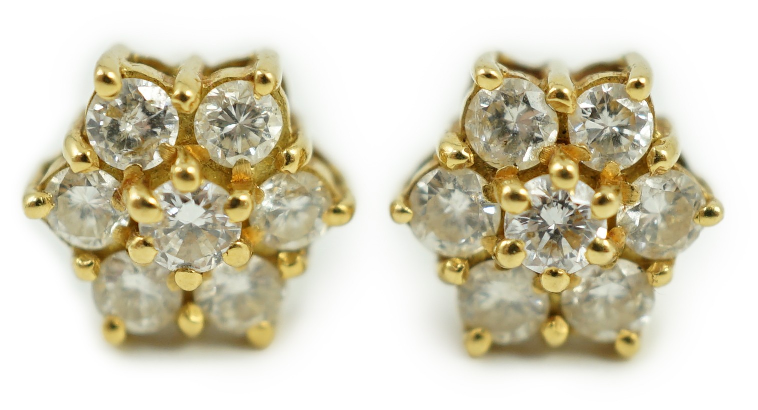 A pair of yellow metal and seven stone diamond cluster set ear studs, 7mm, gross weight 2.8 grams.                                                                                                                          