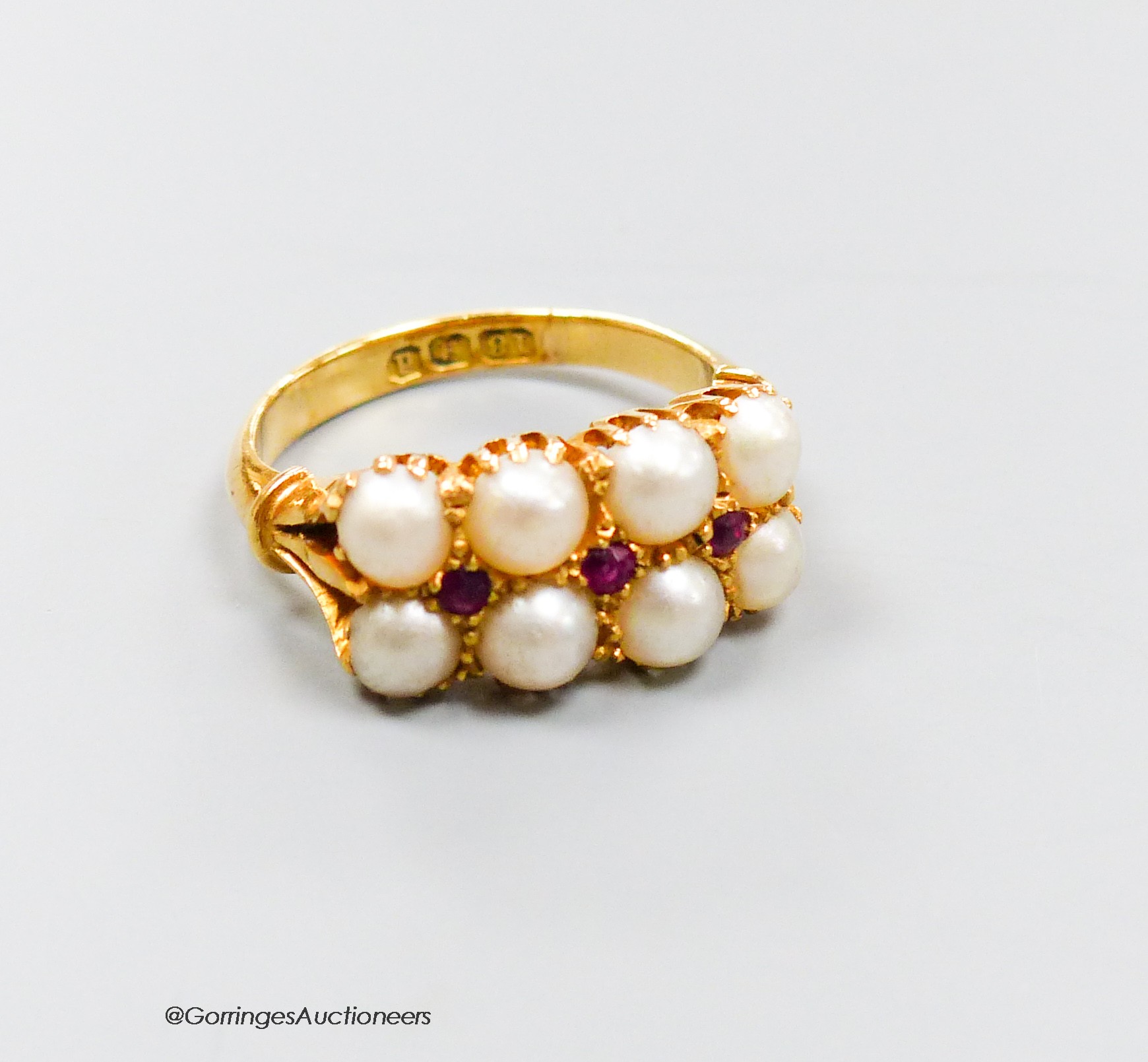 An 18ct gold split pearl and ruby cluster ring, size J/K, gross 5.3 grams.                                                                                                                                                  