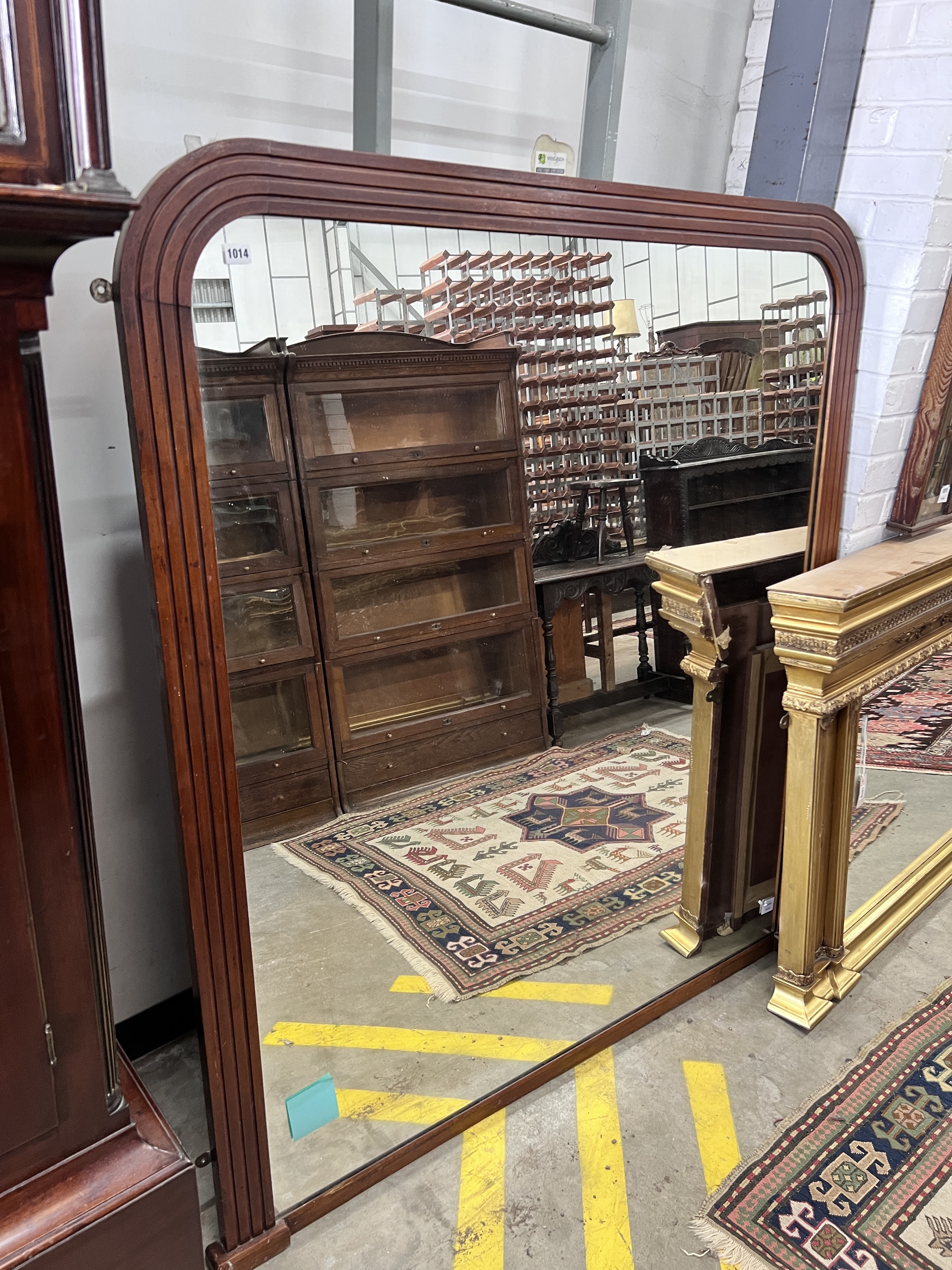 A late Victorian mahogany overmantel mirror, width 140cm, height 143cm                                                                                                                                                      