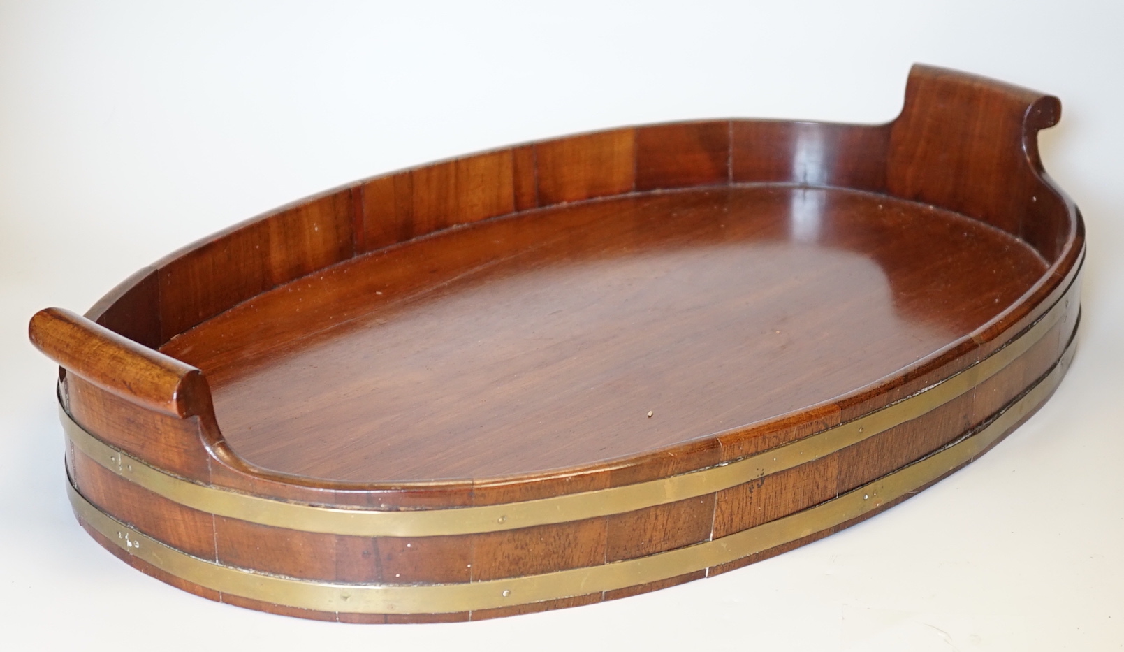 A late Georgian brass-bound mahogany tray, 58cm wide                                                                                                                                                                        