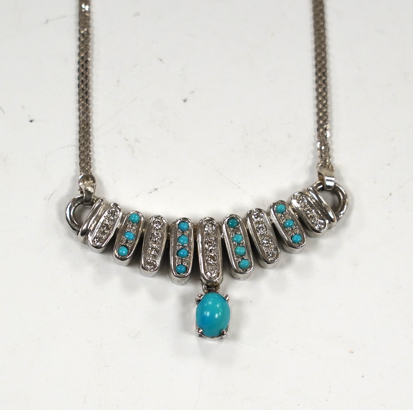 A modern Italian 750 white metal turquoise and diamond cluster set drop necklace, 40cm gross weight 17.1 grams.                                                                                                             