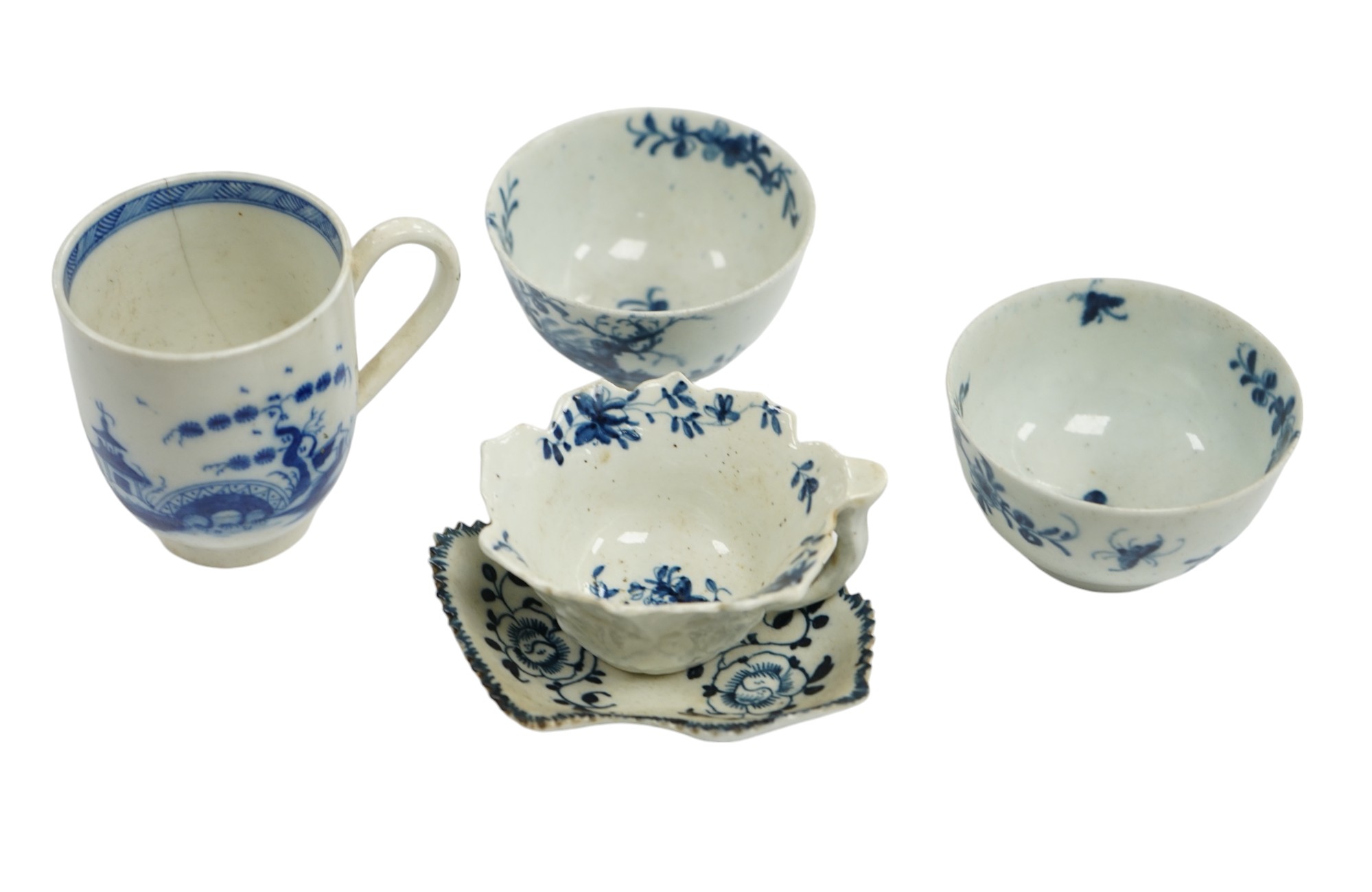 A group of first period blue and white Worcester, including a leaf cup and saucer, two tea bowls and a handled cup, leaf saucer 9.5cm wide (5). Condition - leaf cup cracked, two tea bowls good handled cup, bowl cracked  