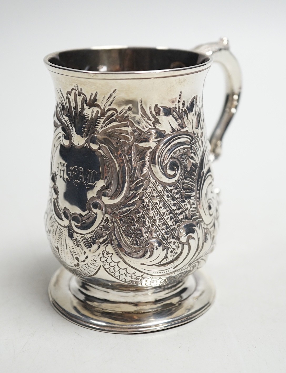 A George III silver baluster mug, with later embossed decoration, John King, London, 1775, height 93mm, 5.2oz.                                                                                                              