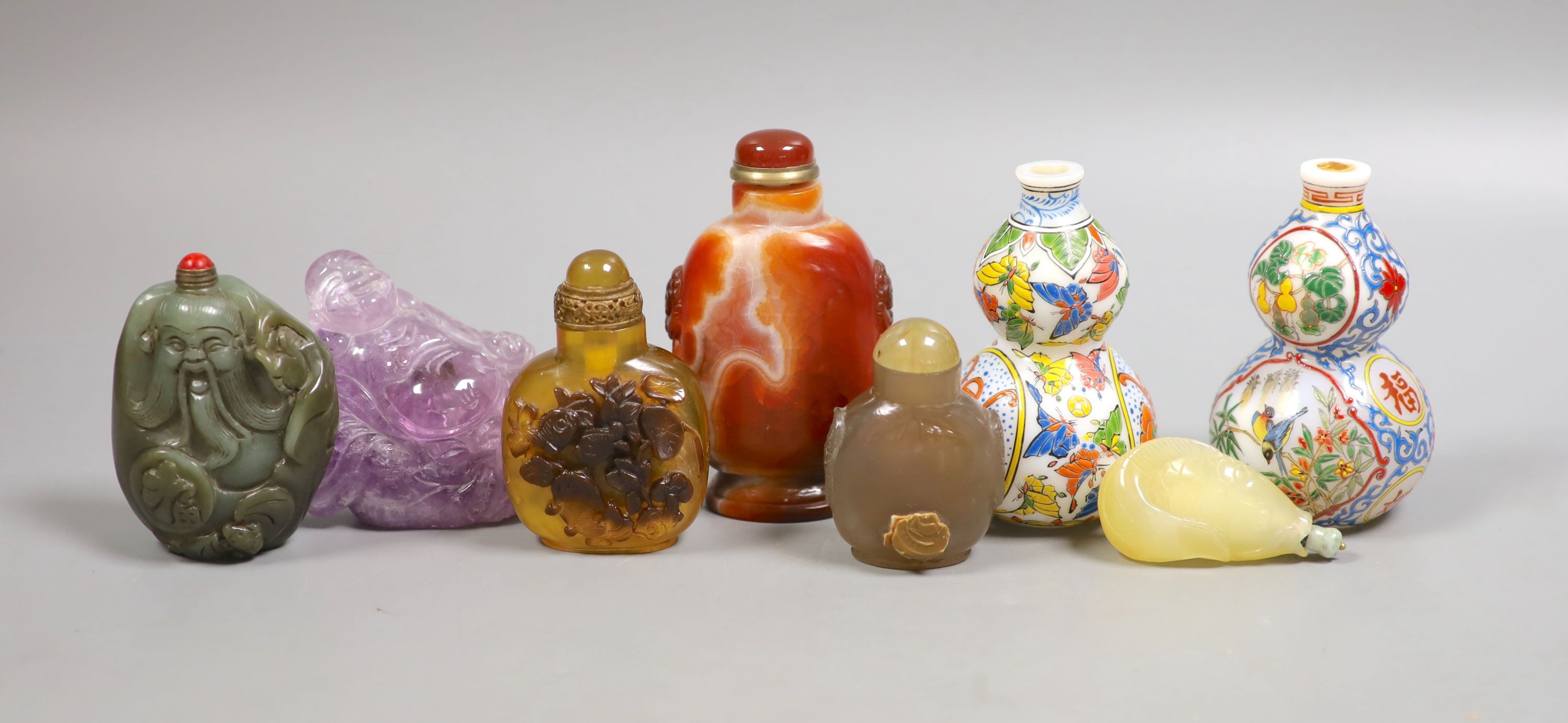 A group of Chinese jade, hardstone and glass snuff bottles, tallest 9.5 cm                                                                                                                                                  