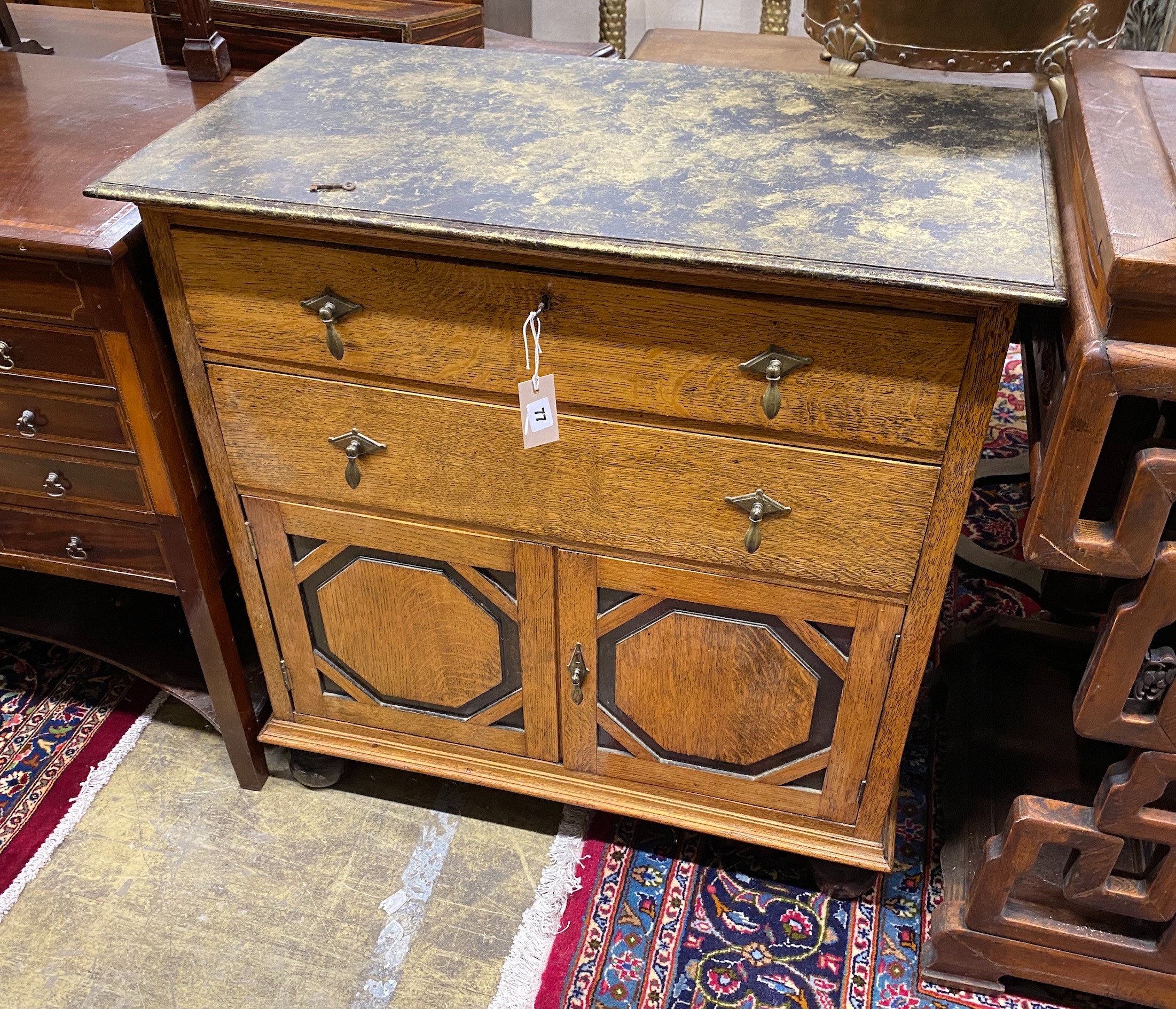 A 1920's oak side cabinet with painted faux marble top, width 83cm, depth 46cm, height 86cm                                                                                                                                 