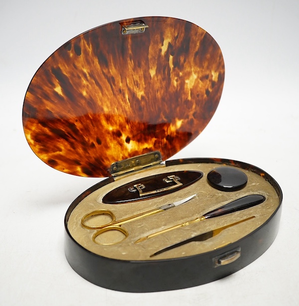 A George V silver gilt mounted tortoiseshell necessaire set, mm. C D, London 1922, 17.5cm wide. Condition - fair to good                                                                                                    