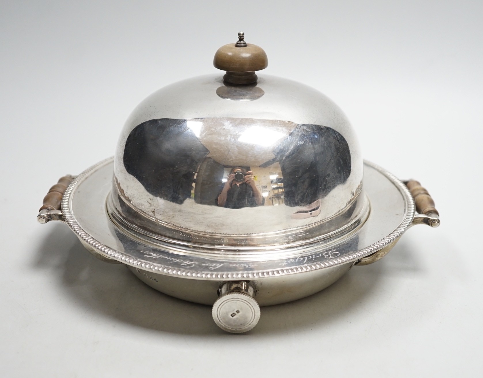 A George V silver circular two handled warming dish and cloche, by J. Parkes & Co, London, 1930, with engraved inscription, width 20.8cm, gross weight 34.4oz.                                                              