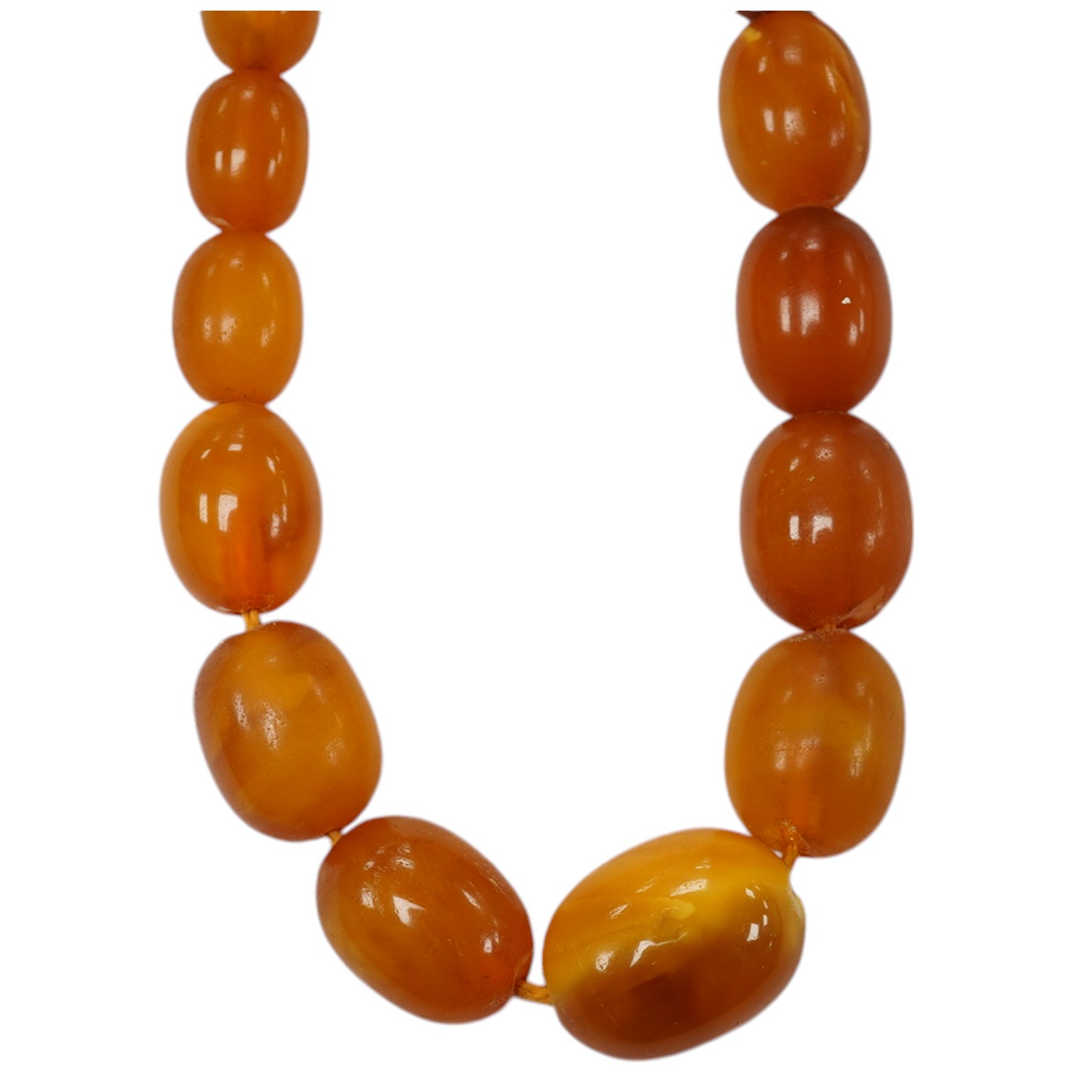 A single strand graduated oval amber bead necklace, 58cm, gross weight 34 grams. Condition - poor to fair                                                                                                                   