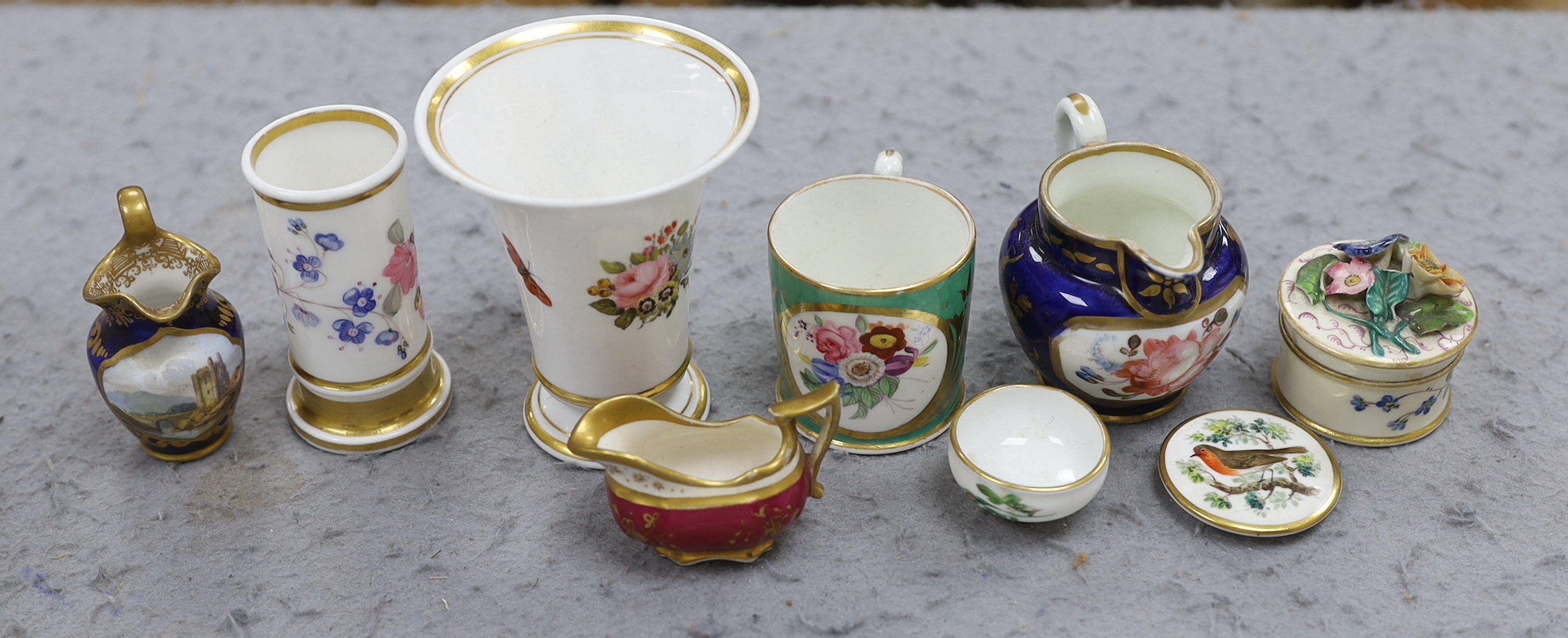 A 19th century Chamberlain Worcester miniature vase painted with flowers, script mark, a miniature jug with painted landscape on a blue ground, probably Chamberlain, an English jug and an English spill vase, an English g