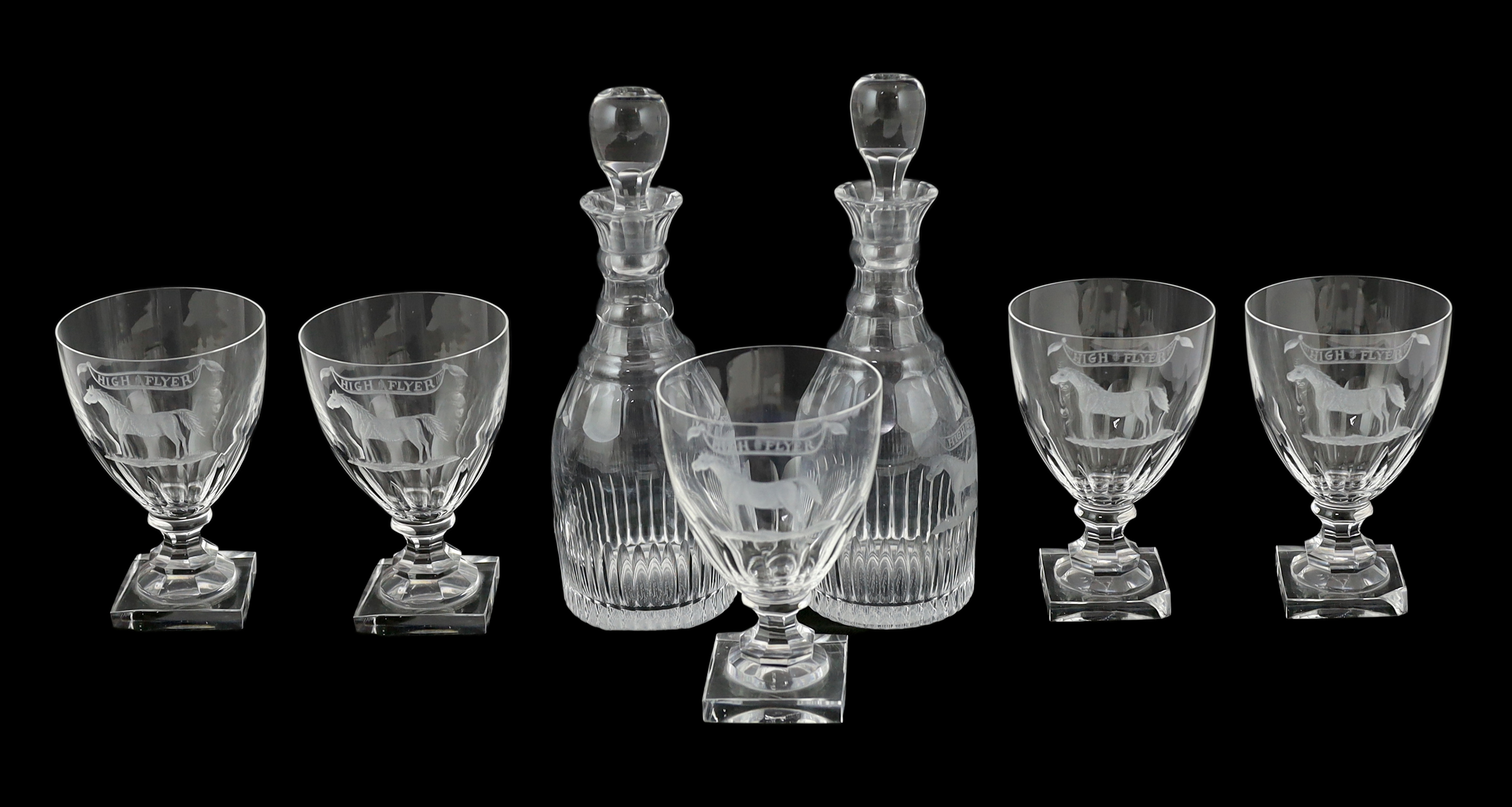 A suite of George III style drinking glassware, consisting, of a pair of decanters and stoppers and five square based rummers, each engraved an image of a racehorse and inscription ‘’High Flyer’’. c.1790. Note: Highflyer