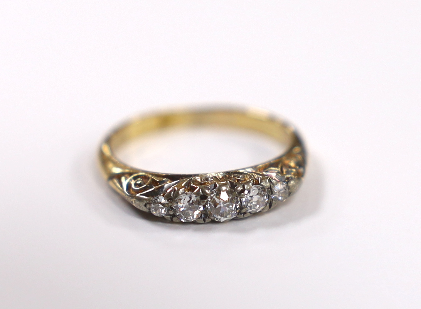 An 18ct and graduated five stone diamond set half hoop ring, size M, gross weight 3.4 grams.                                                                                                                                