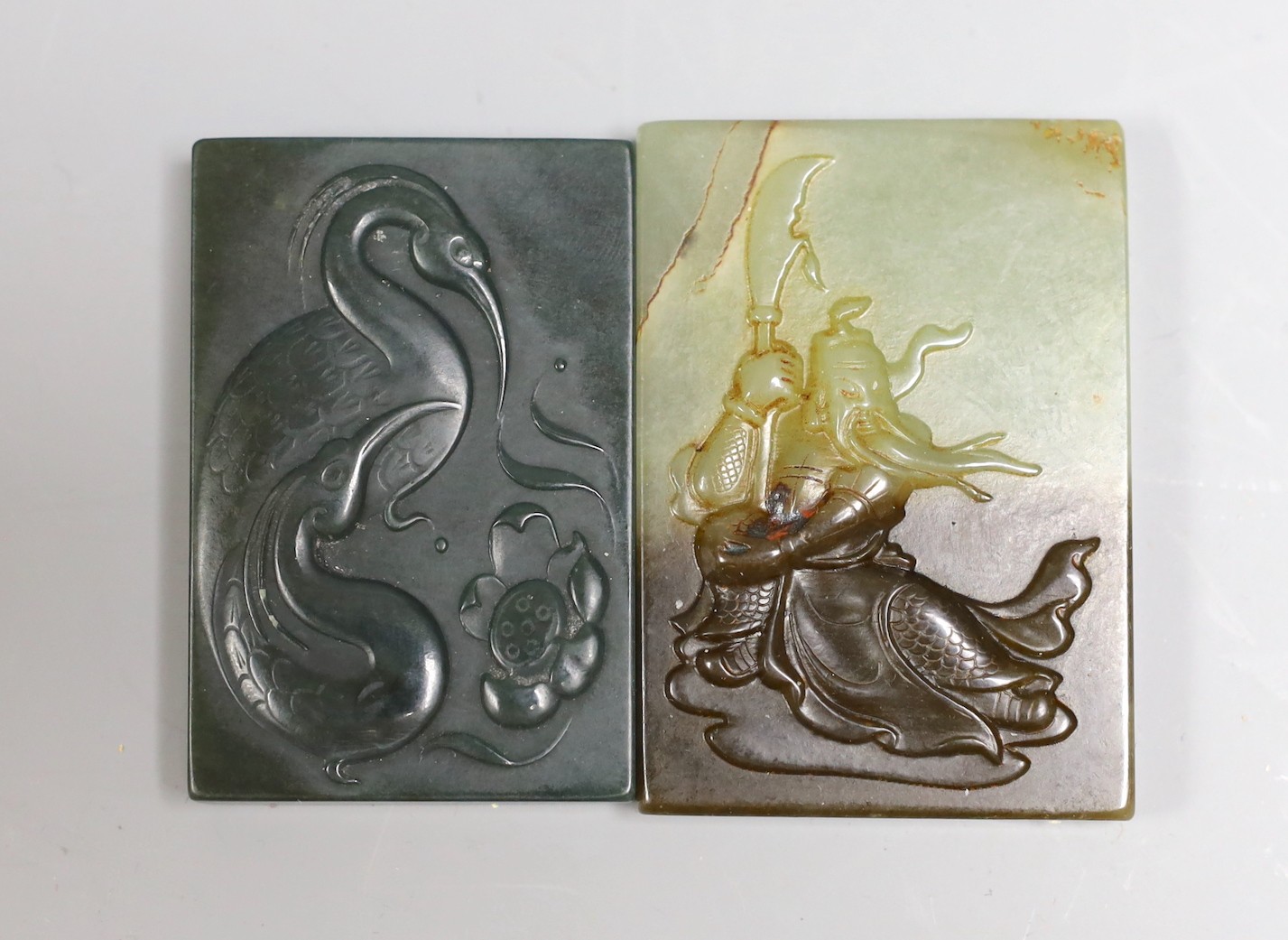 A Chinese russet and pale celadon jade plaque, 6.2cm and another green jade plaque                                                                                                                                          