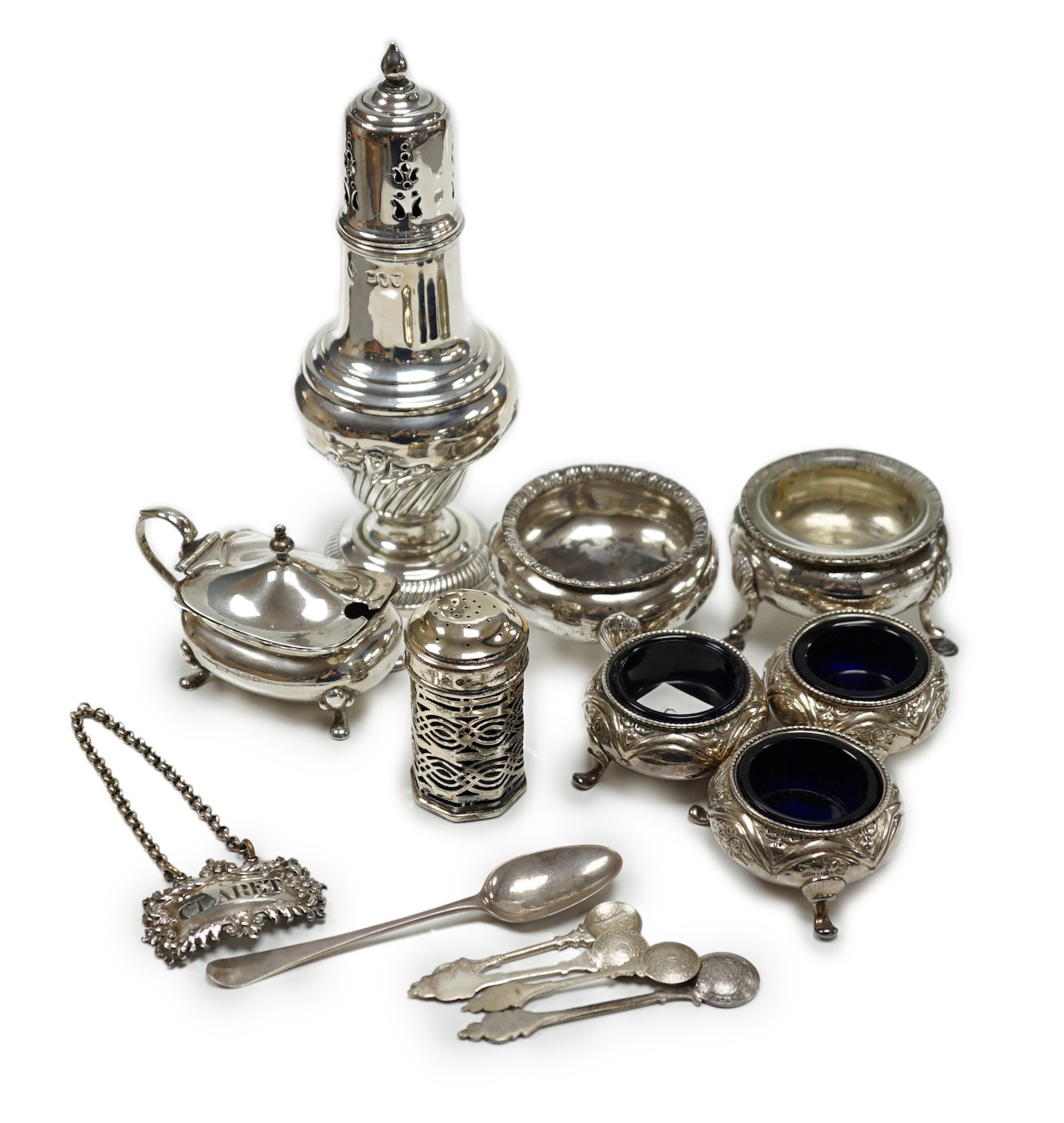 A mixed group of assorted small silver including a sugar caster, two pairs of Victorian bun salts, mustard pot, salt, pepperette, spoon and four white metal spoons.                                                        