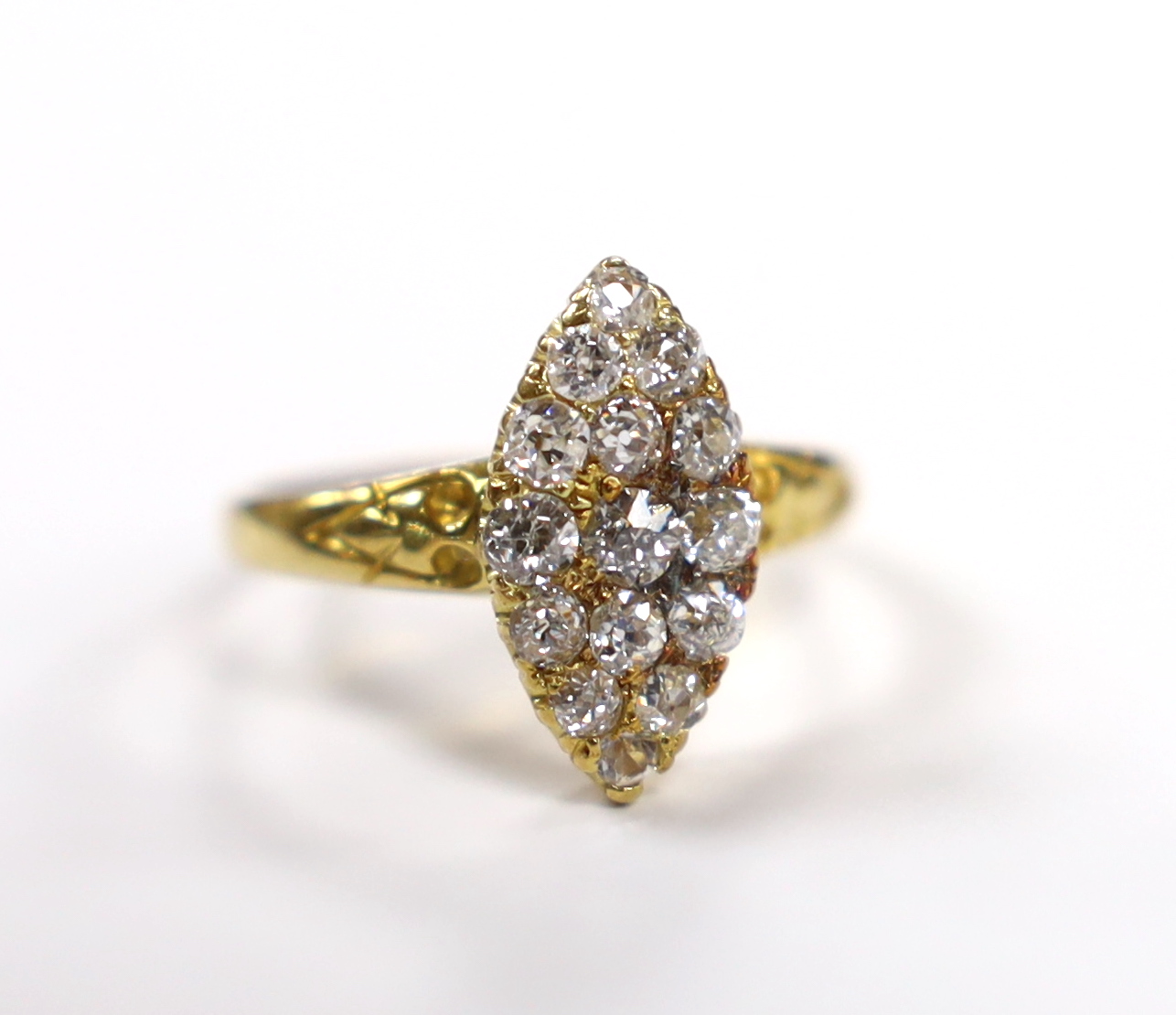 An early 20th century yellow metal and old round cut diamond cluster set marquise shaped ring, size O, gross weight 3.3 grams.                                                                                              