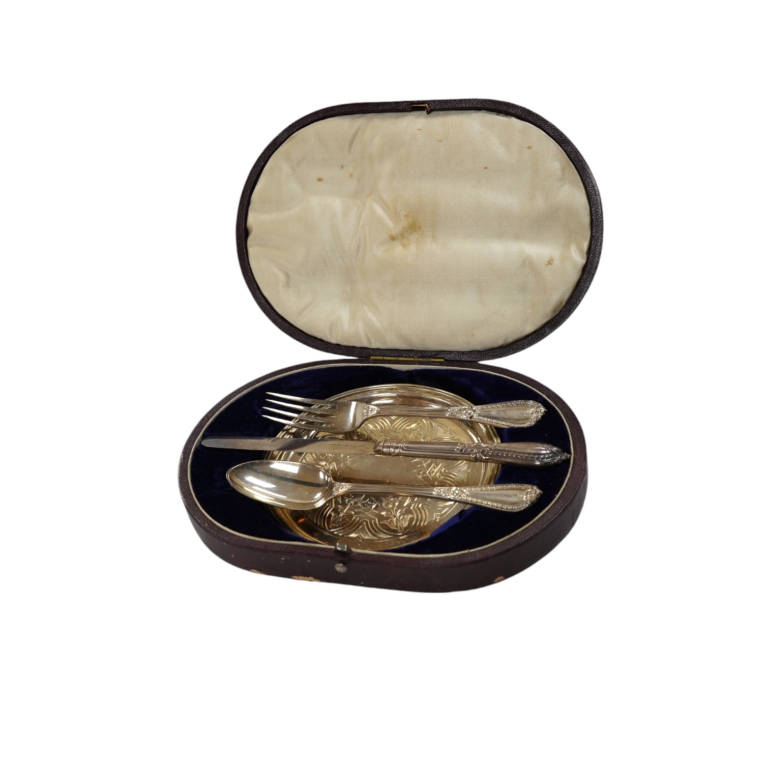 A cased Victorian silver four piece christening set, George Adams, London, 1853 and Henry Wilkinson, Sheffield, 1854. Condition - fair to good                                                                              