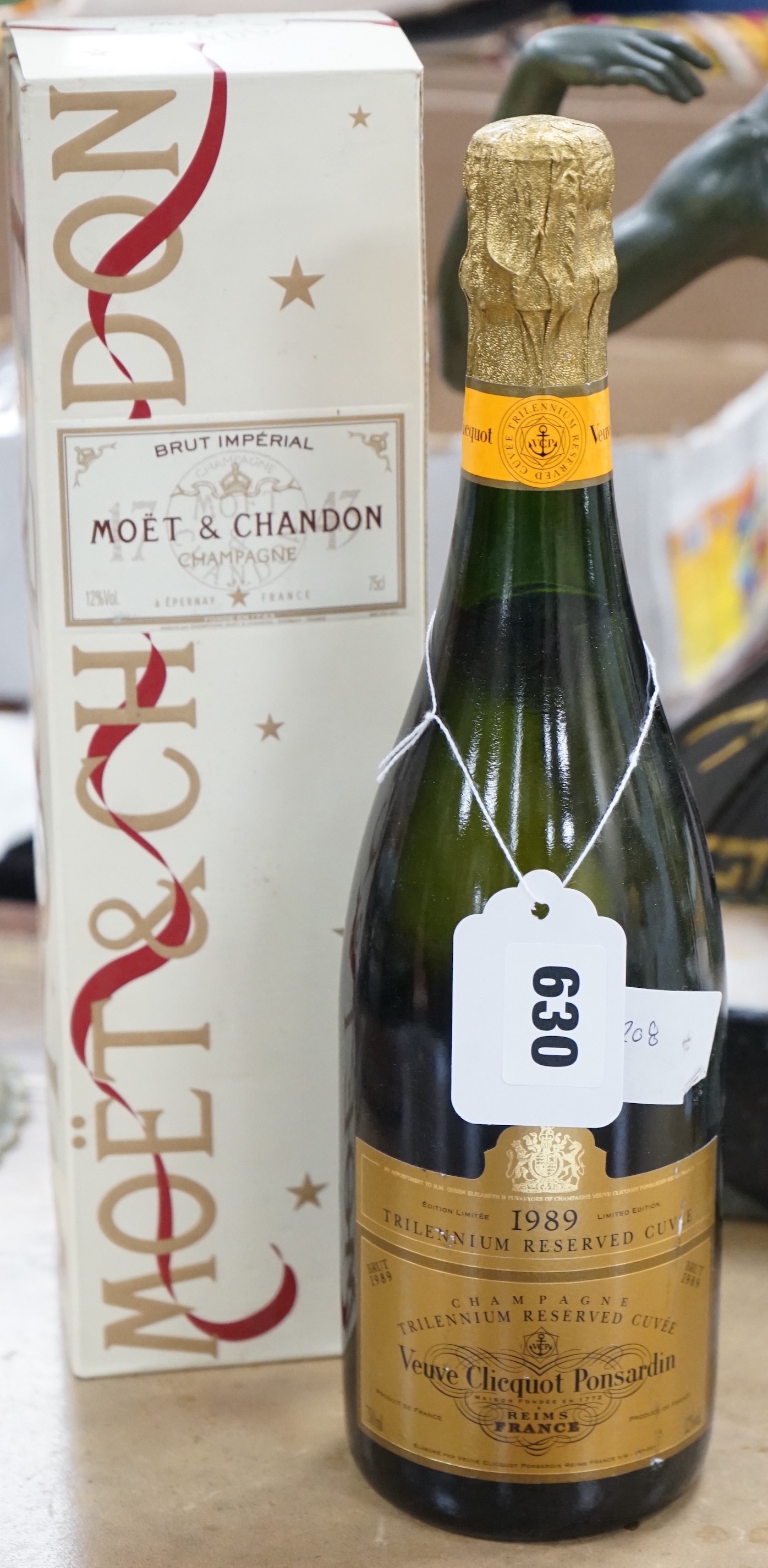 A 1989 bottle of Veuve Cliquot Ponsardin, together with a boxed bottle of Brut Moët & Chandon                                                                                                                               
