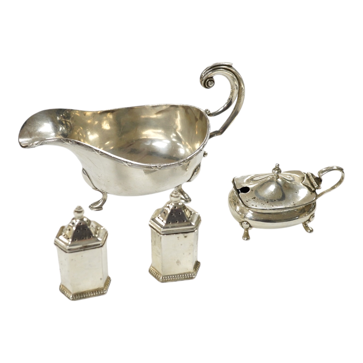 A modern silver sauceboat, 8.4oz and three silver condiments including a pair of pepperettes. Condition - fair                                                                                                              