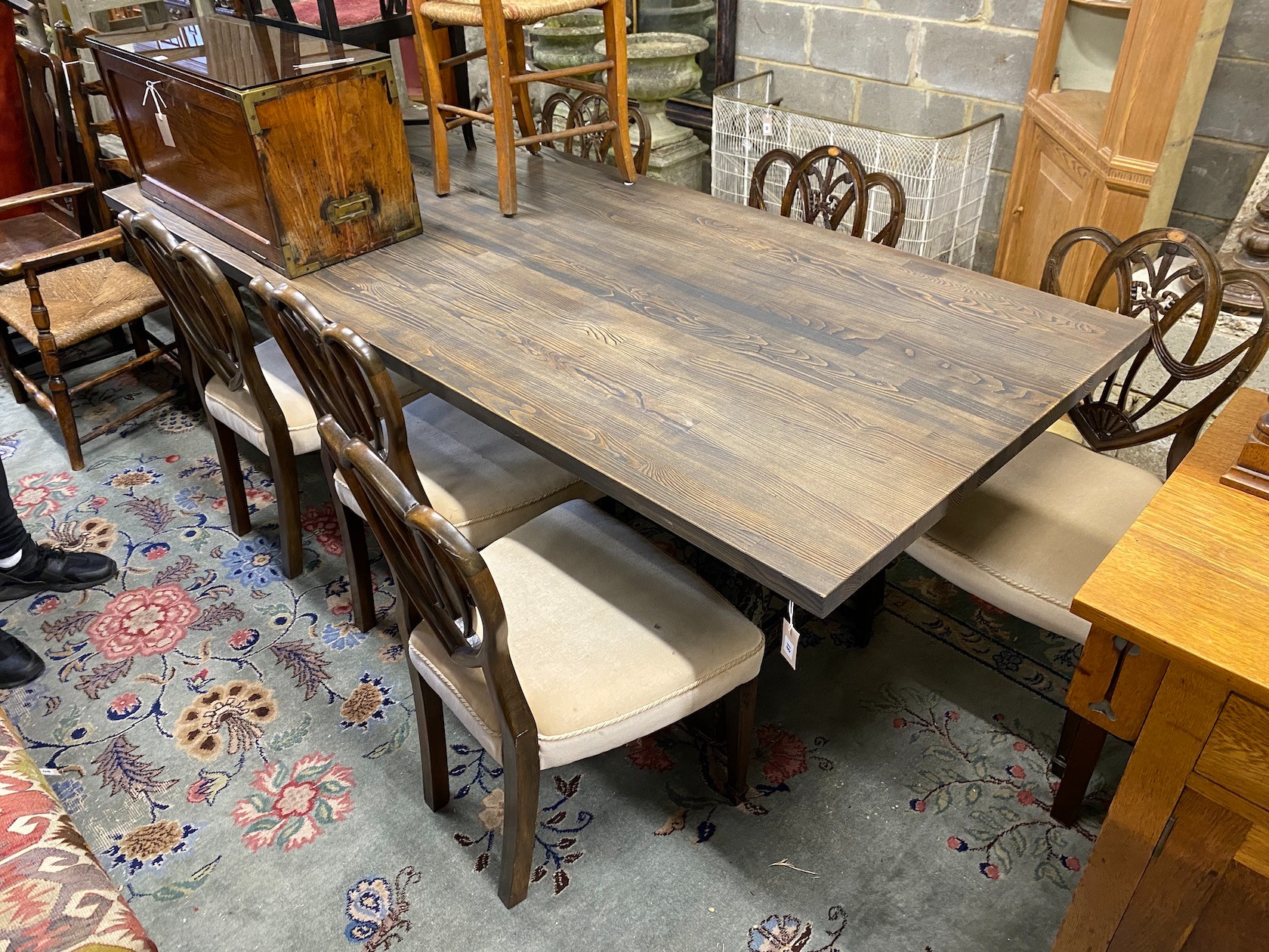 A contemporary industrial style rectangular bleached wood dining table on cast metal base, length 240cm, depth 101cm, height 76cm                                                                                           
