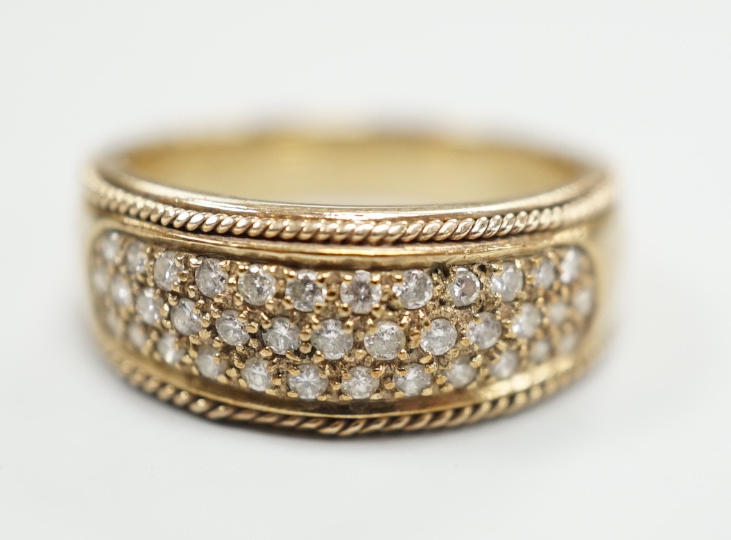 A modern 9ct gold and pave diamond chip set ring, size M/N, gross weight 4.5 grams.                                                                                                                                         