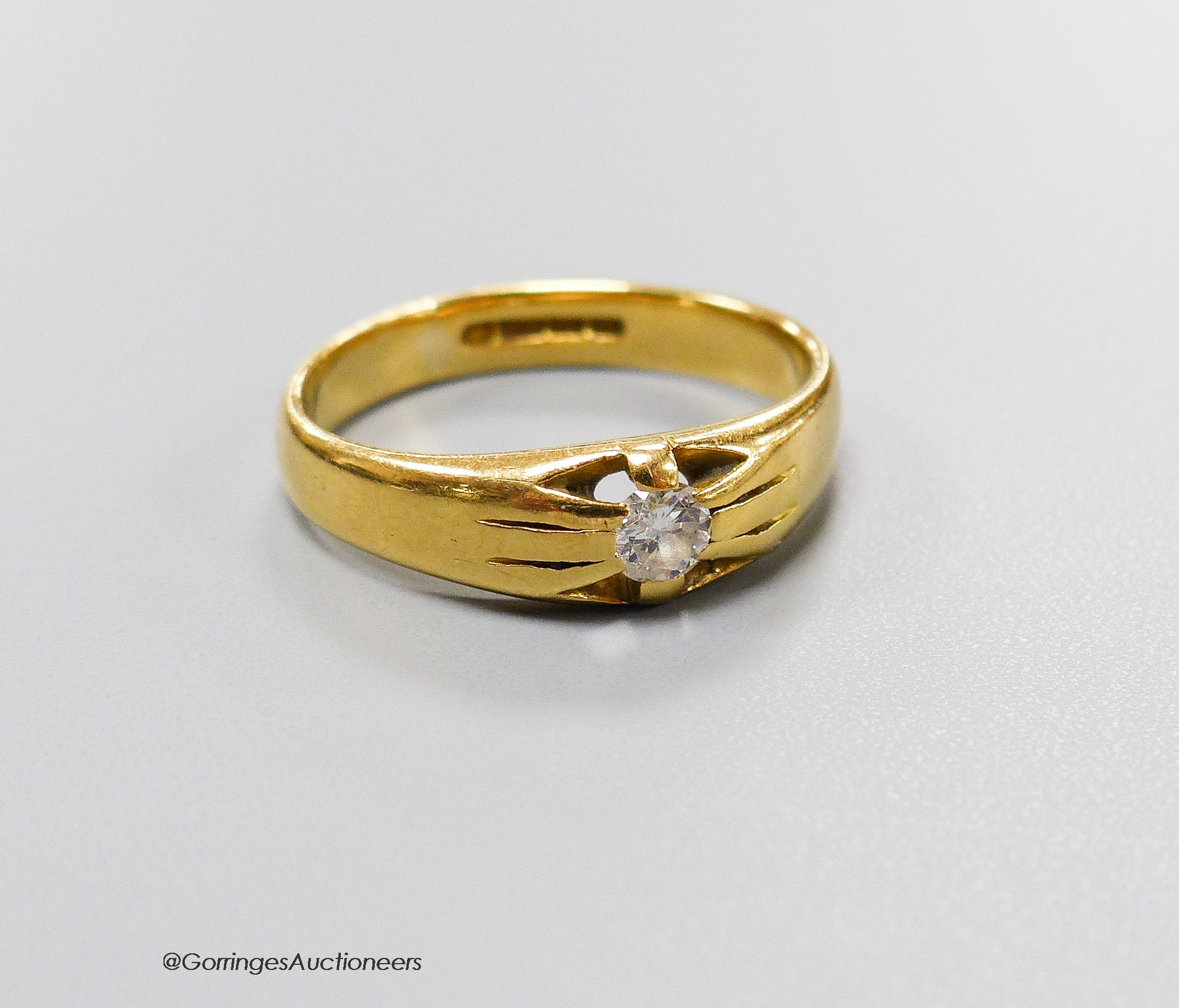 An 18ct gold and claw set solitaire diamond ring, size Q, gross 5.5 grams.                                                                                                                                                  