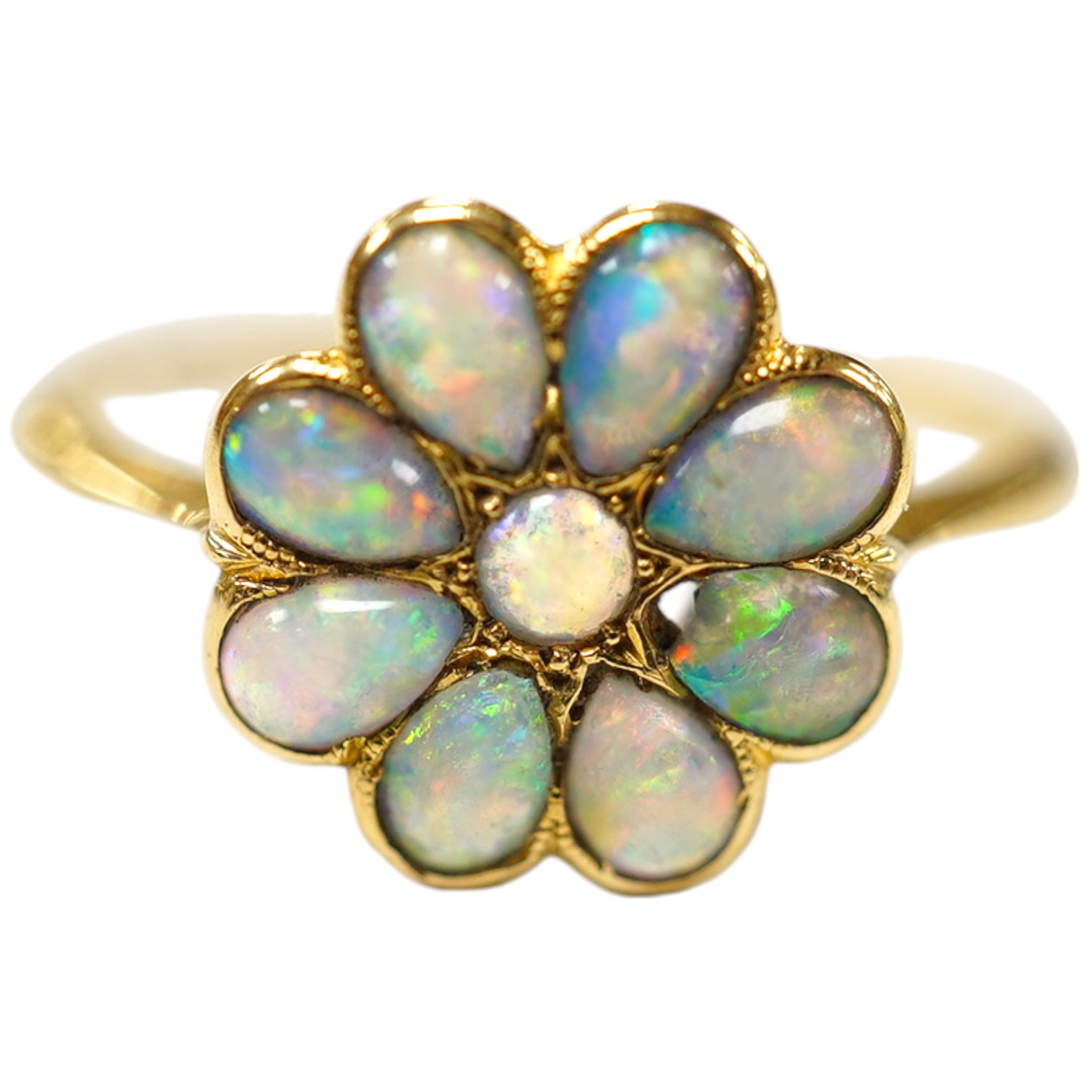 An 18ct and white opal set flower head cluster ring, size N, gross weight 1.7 grams. Condition - poor                                                                                                                       