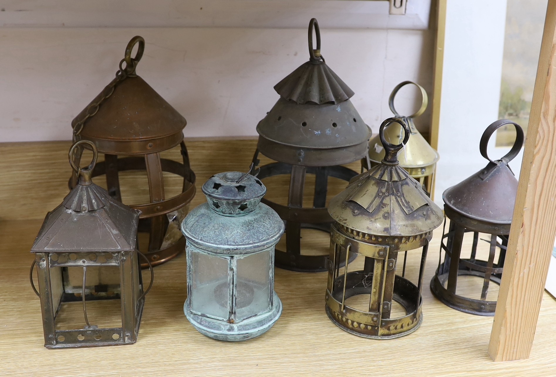 Seven brass and copper lanterns, tallest 35cms high                                                                                                                                                                         